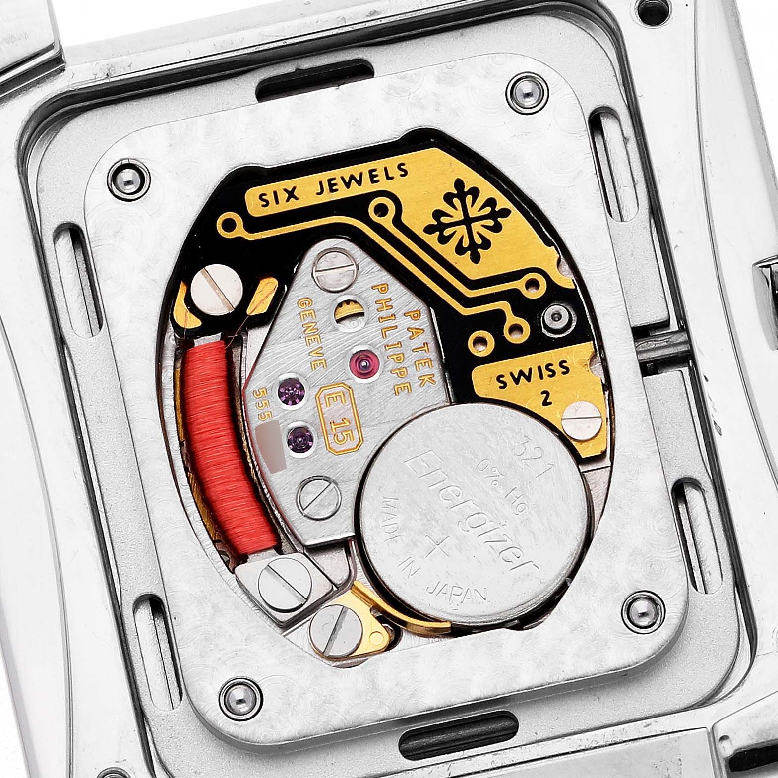 The image shows the movement and internal mechanism of a Patek Philippe Twenty-4 4910/10A-010 Women's Stainless Steel Grey Dial watch, focusing on its battery and components.