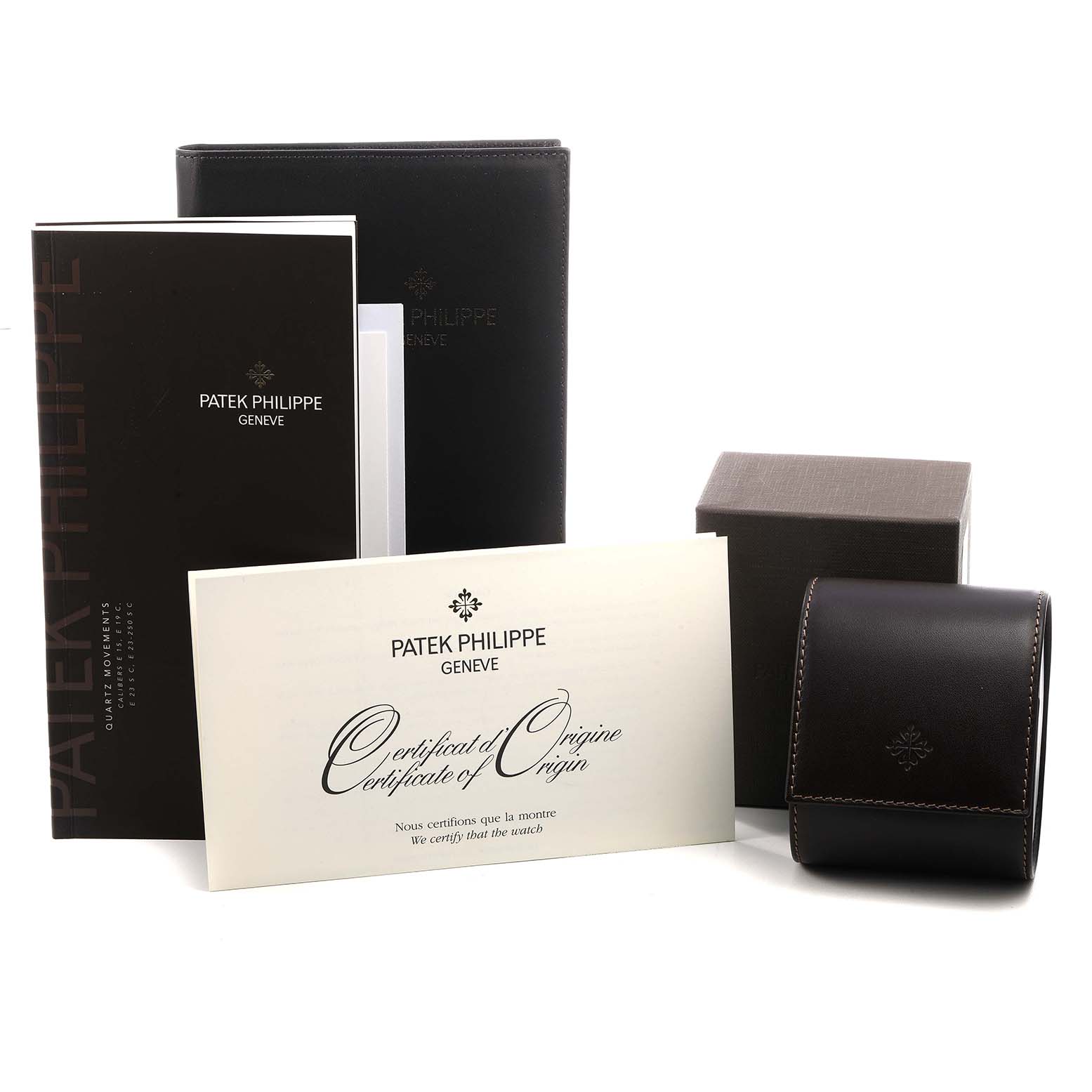 The image shows the Patek Philippe Twenty-4 4910/10A-010 Women's Stainless Steel Grey Dial accessories, including a certificate, manual, leather pouch, and box, from a front angle.