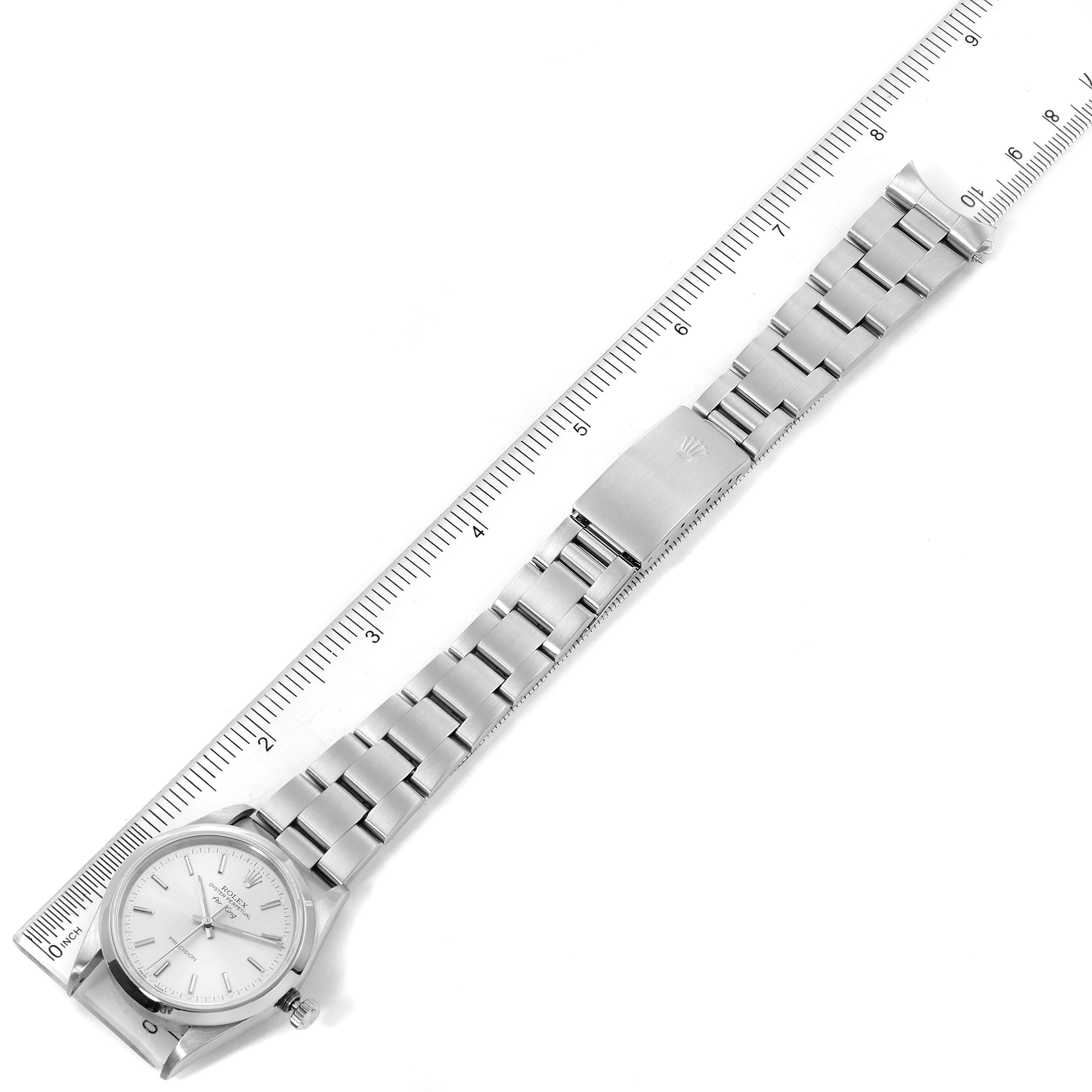 The image shows a top-down view of the Rolex Air-King 14000 Men's Stainless Steel Silver Dial 14000 Men's Stainless Steel Silver Dial watch, including its face, bracelet, and clasp, with a ruler for scale.