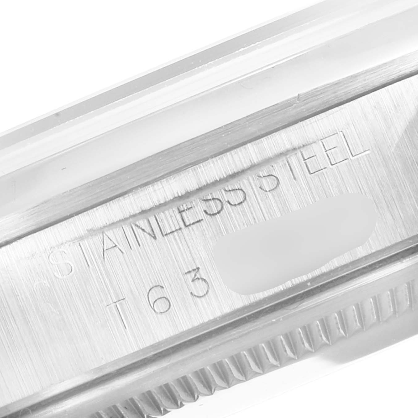 This close-up image shows the side of the stainless steel case of a Rolex Air-King 14000 Men's Stainless Steel Silver Dial 14000 Men's Stainless Steel Silver Dial watch, including some engraved text.