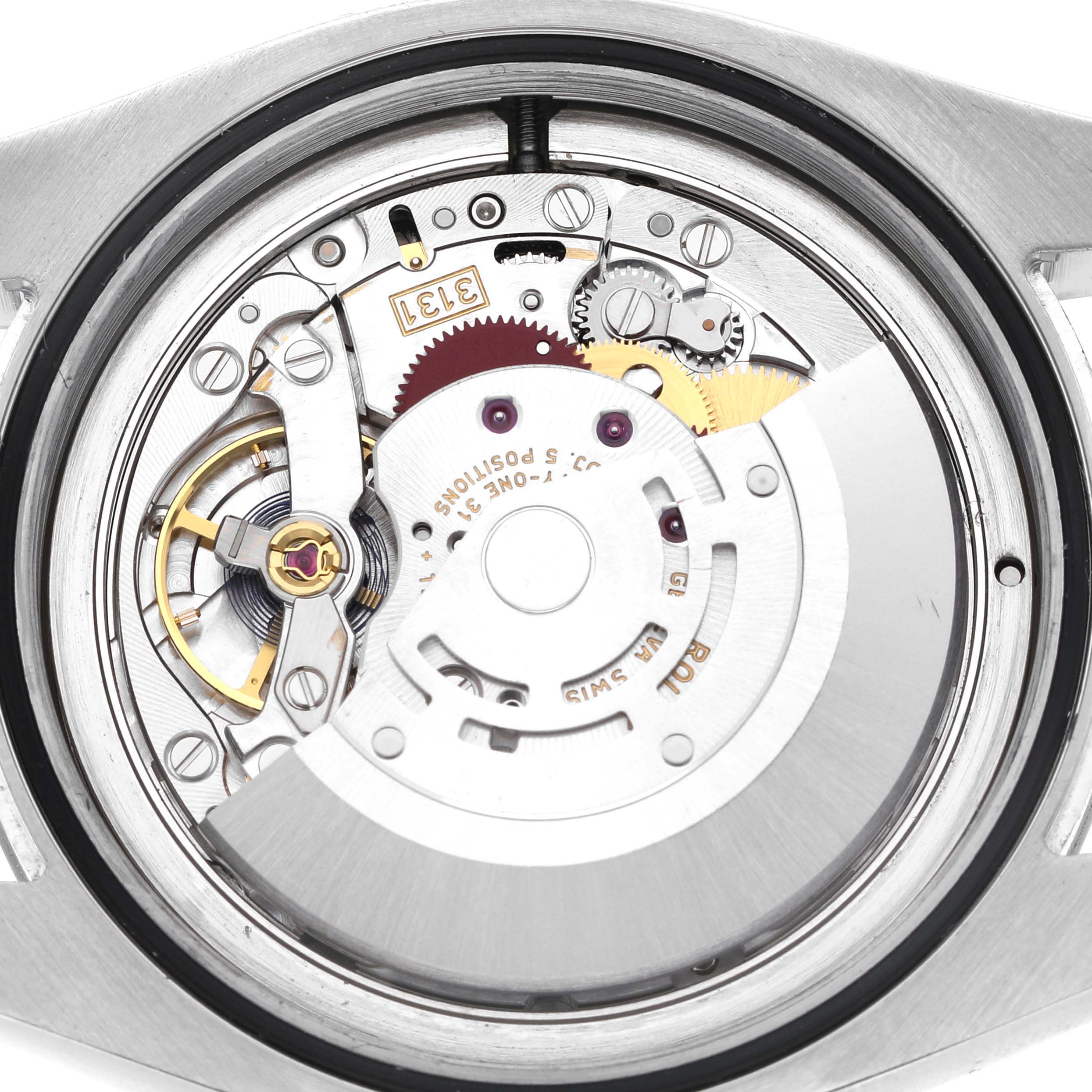 The image shows the intricate movement inside a Rolex Air-King 116900 Men's Stainless Steel Black Dial, viewed from the back.