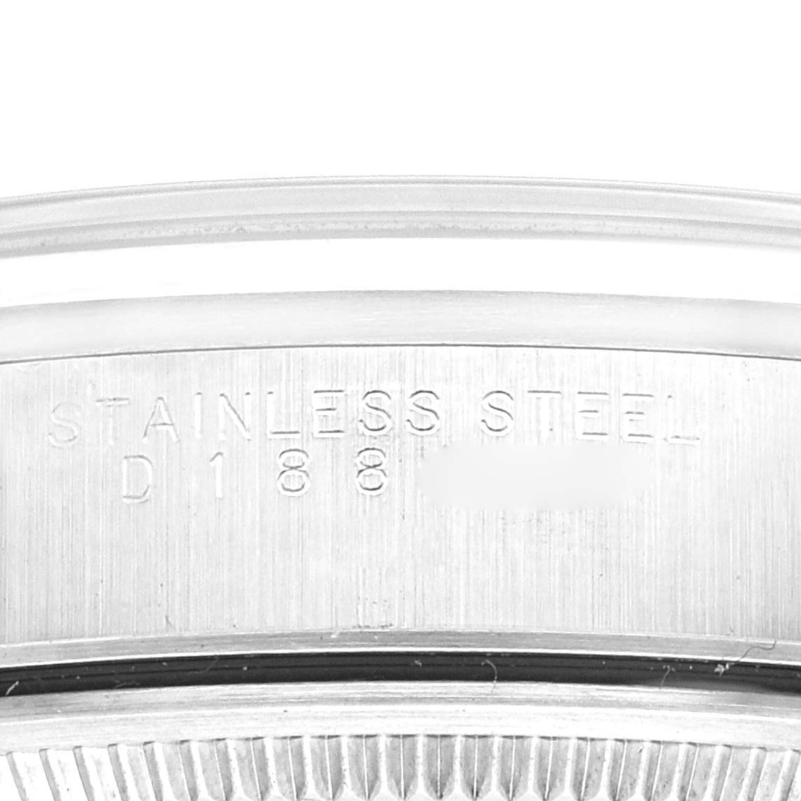 The image shows a close-up view of the stainless steel case back of a Rolex Air-King 14000 Men's Stainless Steel Silver Dial 14000 Men's Stainless Steel Silver Dial watch, highlighting engraving details.