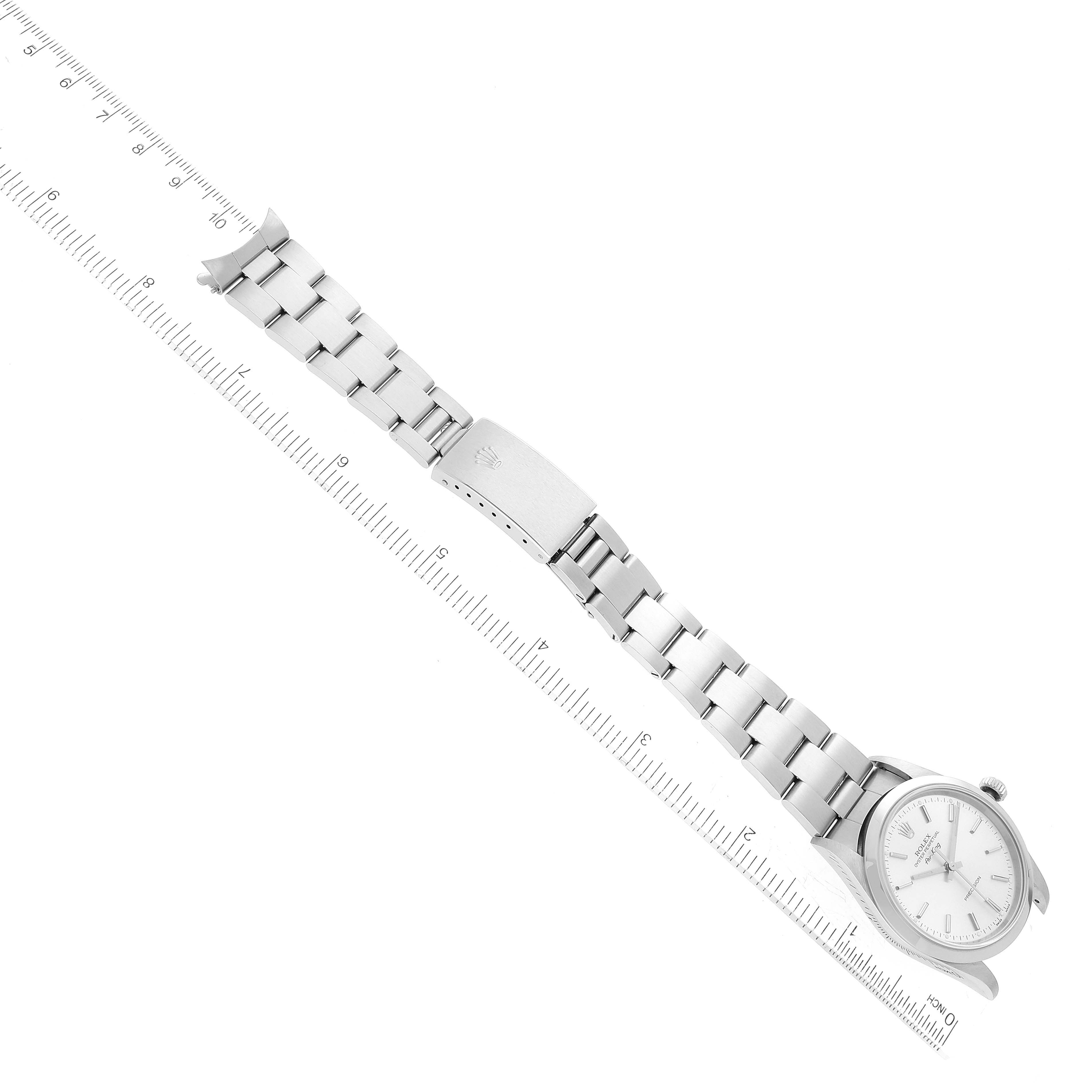 The image shows a side view of a Rolex Air-King 14000 Men's Stainless Steel Silver Dial 14000 Men's Stainless Steel Silver Dial watch with its face, clasp, and bracelet visible alongside a measurement scale.