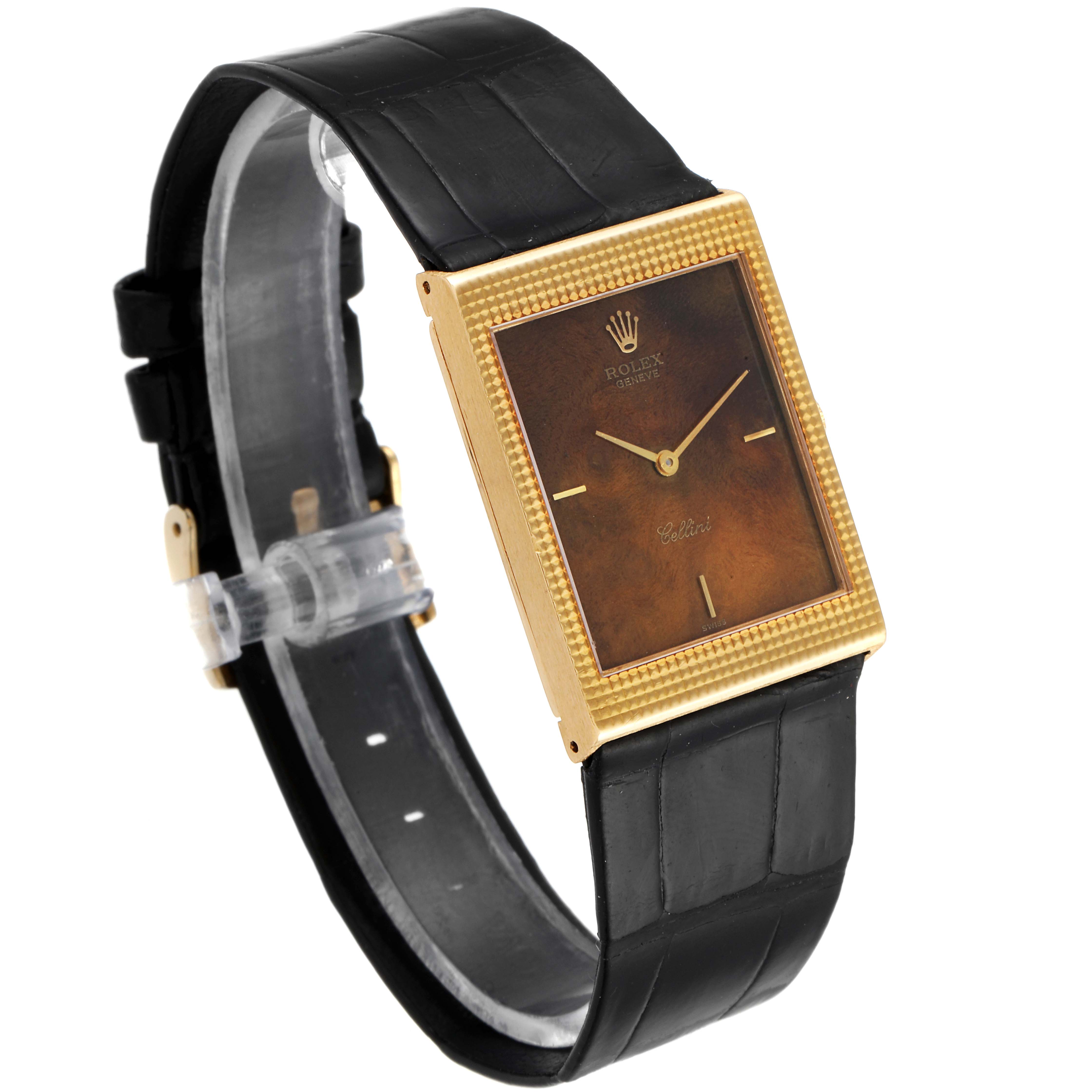 The Rolex Cellini 4127 Men's Yellow Gold Brown Dial 4127 Men's Yellow Gold Brown Dial watch is shown at a slight angle, highlighting the gold rectangular face and black leather strap.