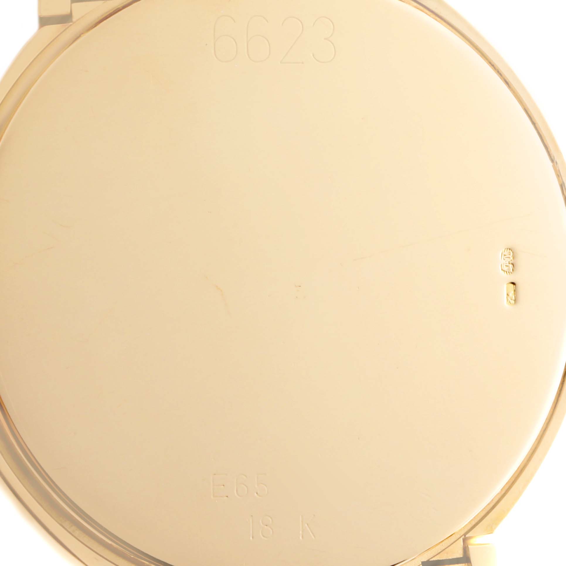 The image shows the back case of a Rolex Cellini 6623 Men's Yellow Gold Champagne Dial 6623 Men's Yellow Gold Champagne Dial watch, highlighting its smooth, golden surface and engraved markings.