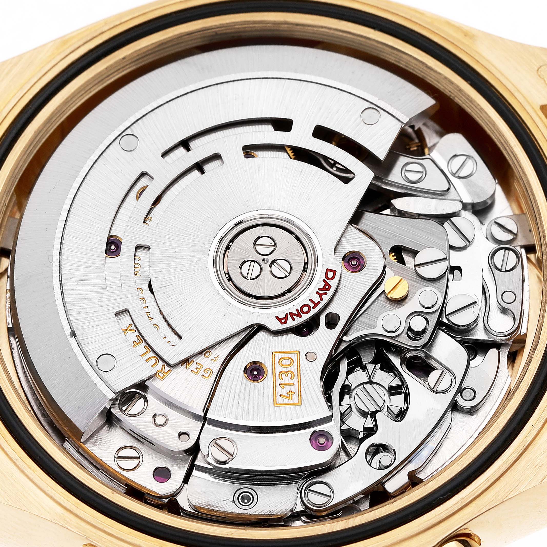 The image shows the internal movement of a Rolex Daytona 116518 Men's Yellow Gold Blue Dial watch viewed from the back, highlighting its intricate mechanical components.