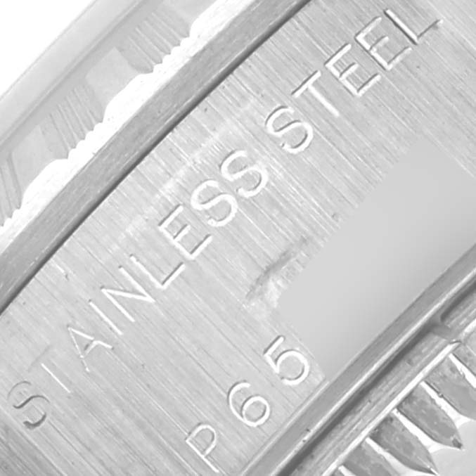 This image shows a close-up of the Rolex Date 79240 Women's Stainless Steel Pink Dial 79240 Women's Stainless Steel Pink Dial model's stainless steel bezel edge, with engraved text visible.