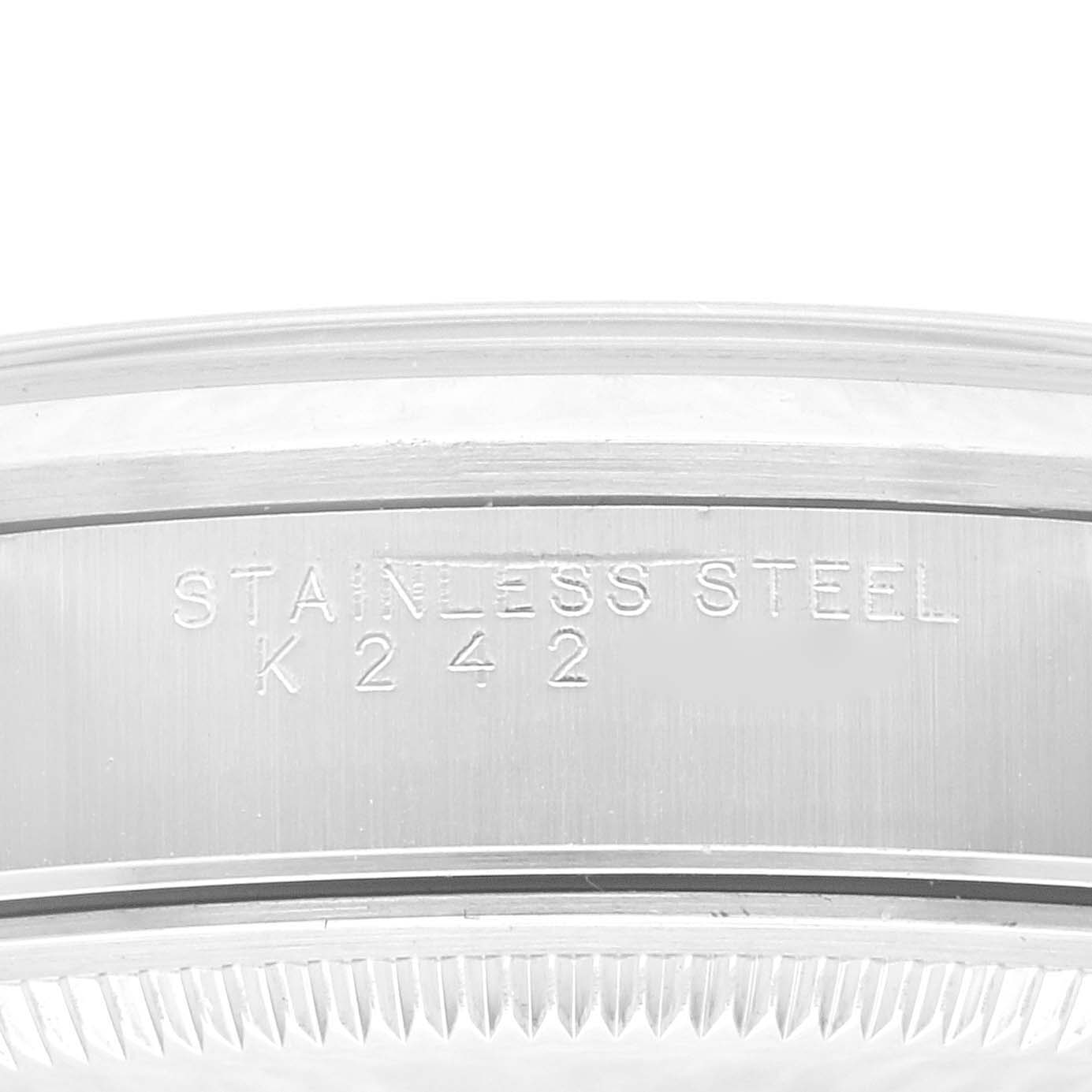 This image shows a close-up of the stainless steel casing of a Rolex Date 15200 Men's Stainless Steel Silver Dial 15200 Men's Stainless Steel Silver Dial model watch, featuring an engraving.