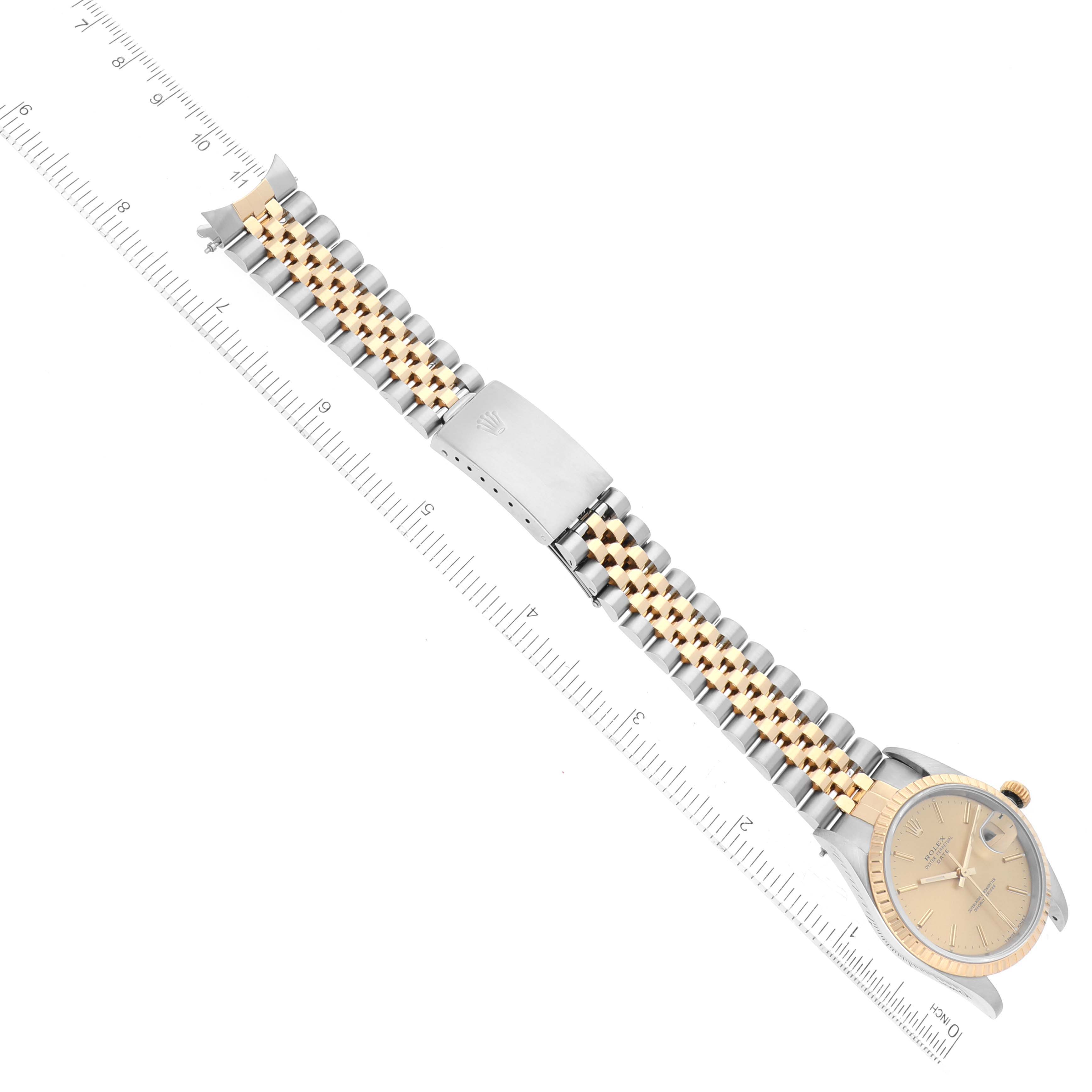 This image shows a Rolex Date 15223 Men's Steel and Gold (two tone) Champagne Dial 15223 Men's Steel and Gold (two tone) Champagne Dial model watch from a top-down angle, highlighting the watch face and the two-tone bracelet.