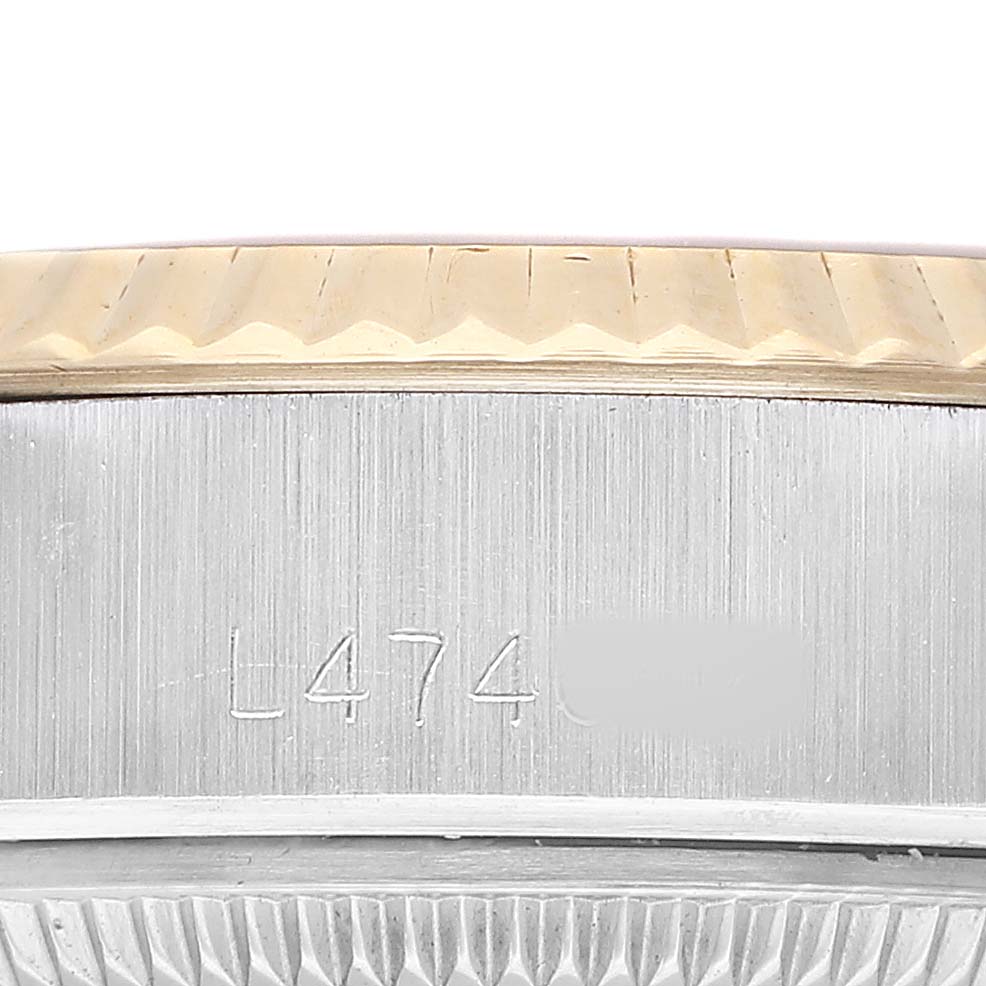 The image shows a close-up side angle of a Rolex Datejust 69173 Women's Steel and Gold (two tone) Champagne Dial's engraved case side and fluted bezel.
