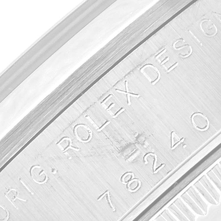 The image shows a close-up view of the caseback of a Mid-Size Rolex watch, featuring engraved text "ROLEX DESIGN."