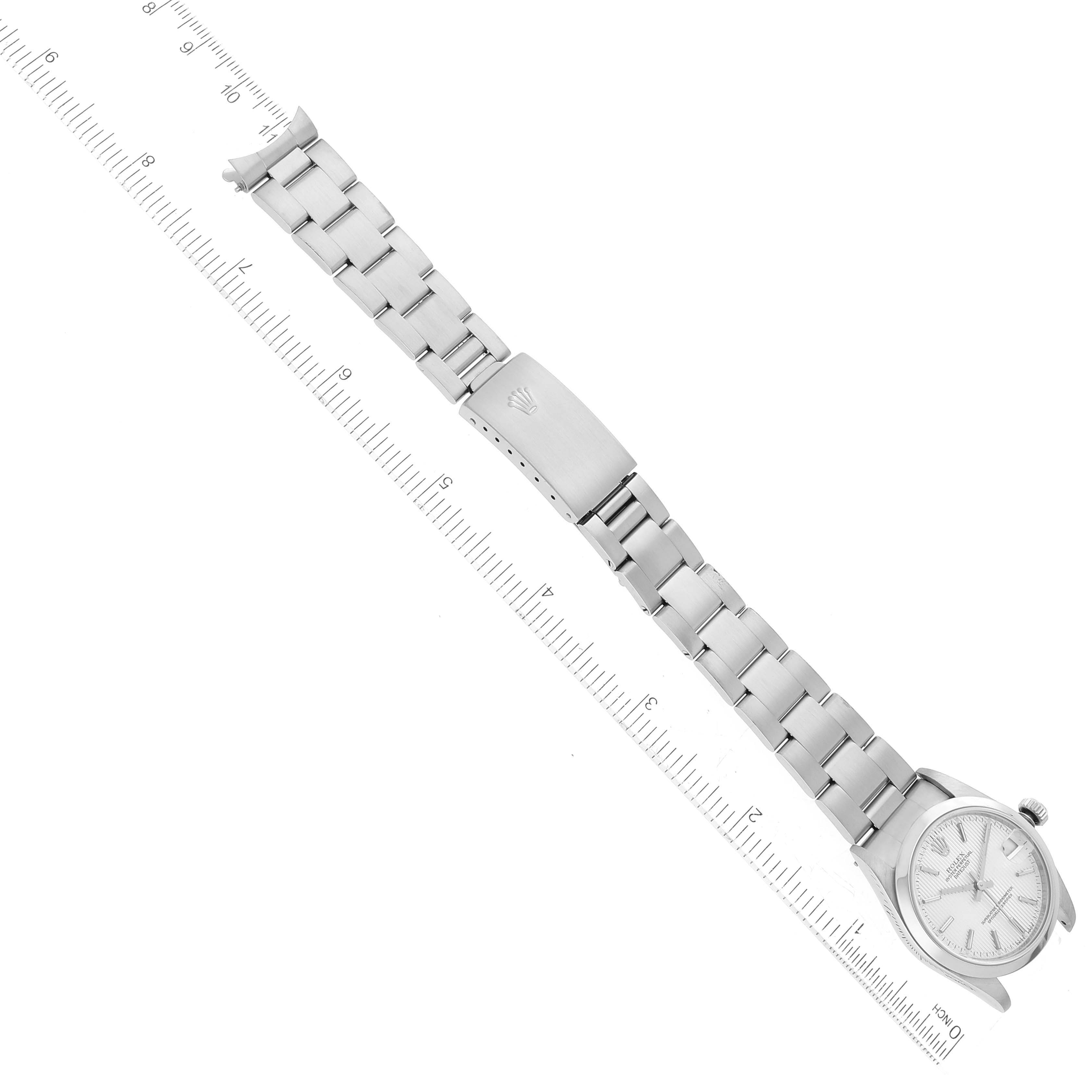 The image shows a Rolex Mid-Size 78240 Women's Stainless Steel Silver Dial 78240 Women's Stainless Steel Silver Dial watch laid flat with its face, bracelet, and clasp visible, placed alongside a ruler.