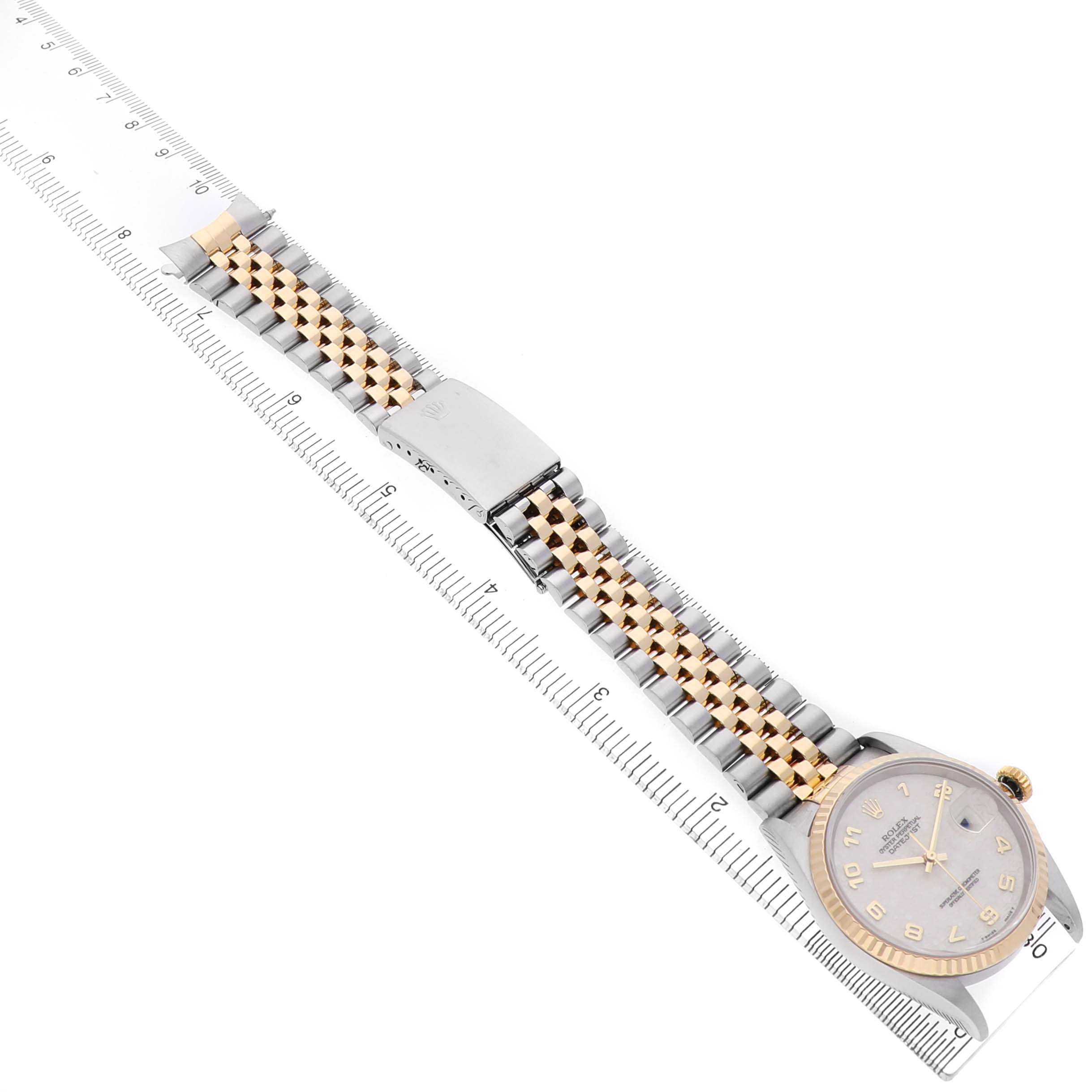 The Rolex Datejust 41 16233 Men's Steel and Gold (two tone) Beige Dial watch is shown from a top-down angle, displaying its face, case, and entire bracelet alongside a ruler.