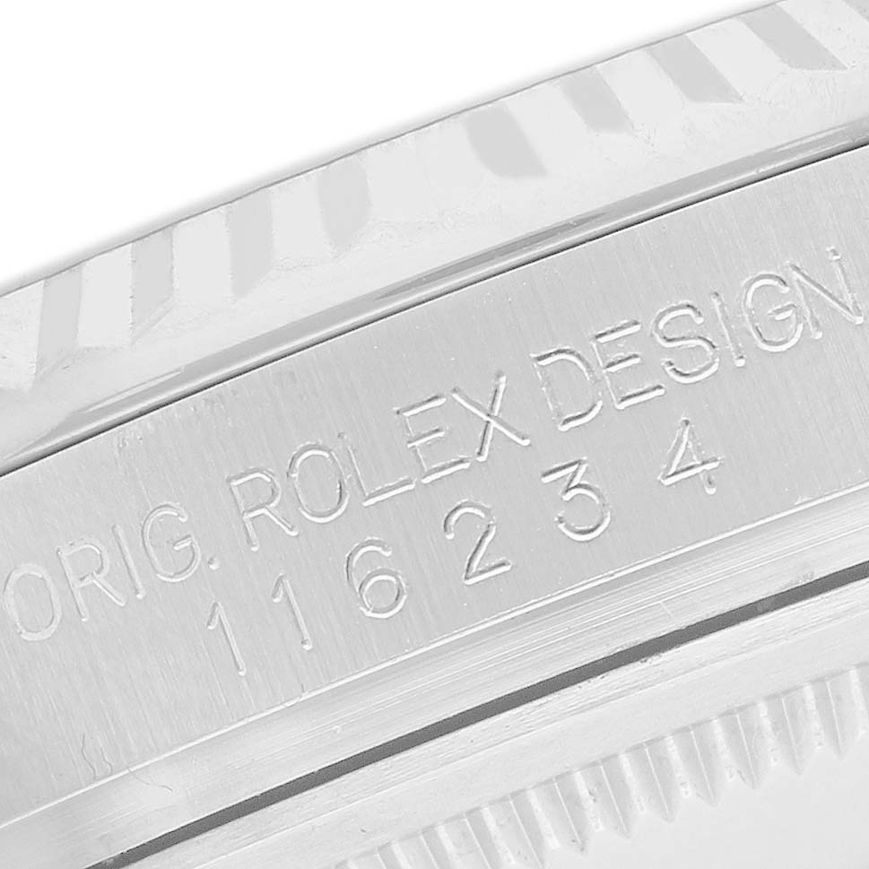 The image shows a close-up of the engraved side of the Rolex Datejust 116234 Men's Stainless Steel Mother of Pearl Dial bezel and case edge.