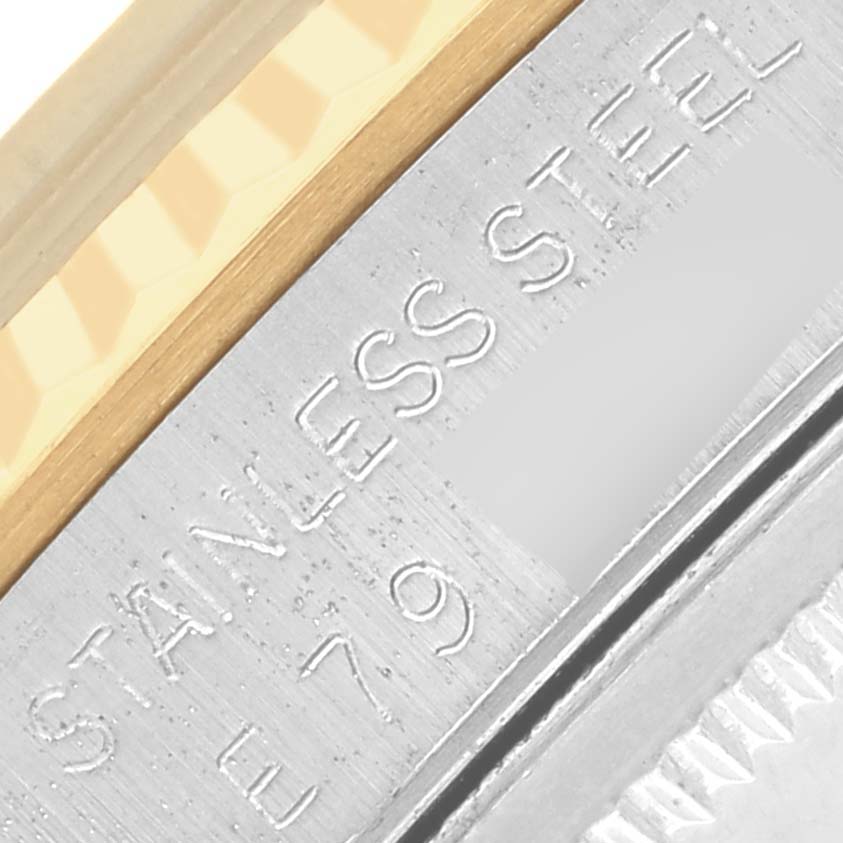 The image shows a close-up of the stainless steel and gold bezel with engraved text on the Rolex Datejust 16233 Men's Steel and Gold (two tone) Blue Dial 16233 Men's Steel and Gold (two tone) Blue Dial.