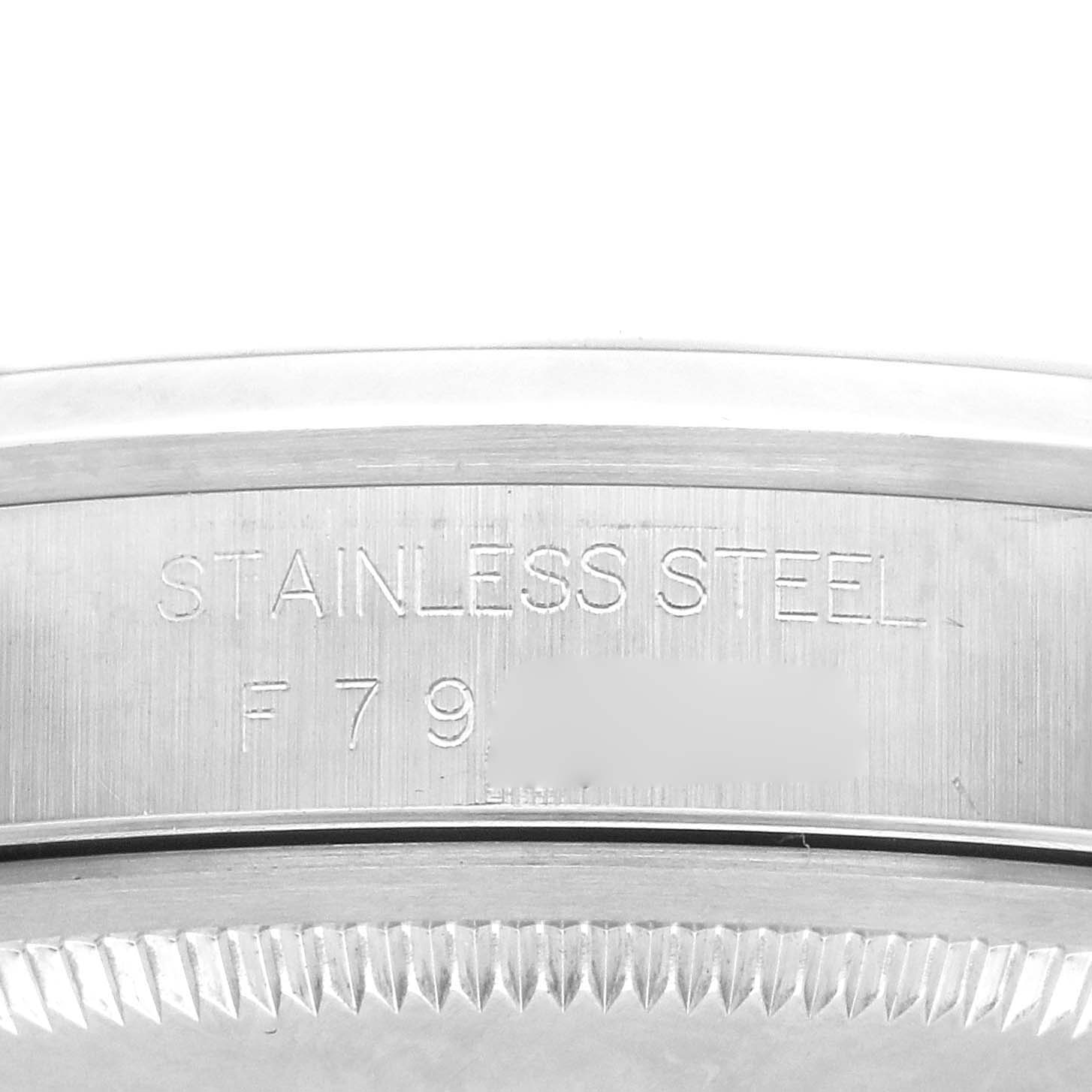 This image shows a close-up of the side of a Rolex Datejust 16200 Men's Stainless Steel White Dial 16200 Men's Stainless Steel White Dial watch, highlighting the stainless steel marking and partial edge of the bezel.