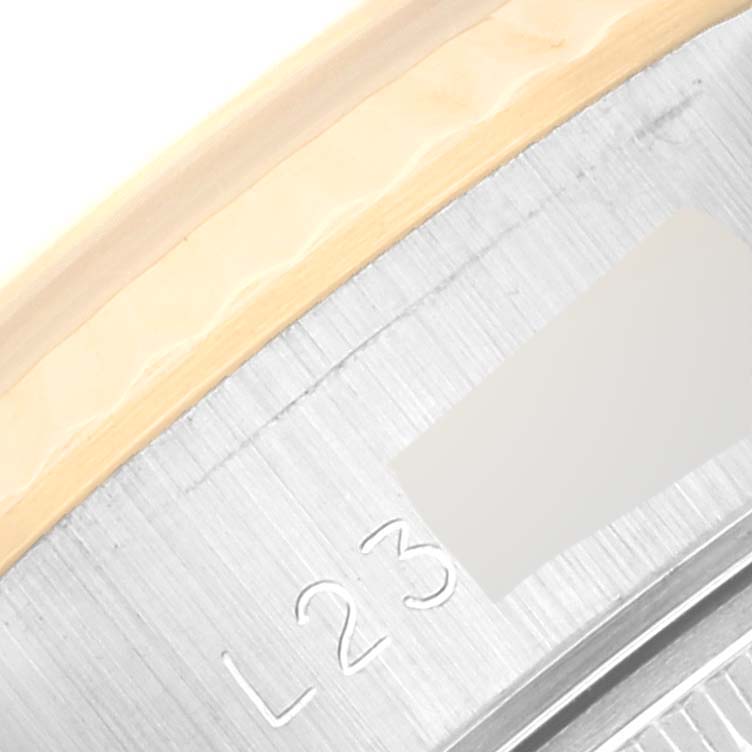 The image shows a close-up of the edge of the bezel and a part of the inner ring of a Rolex Datejust 69173 Women's Steel and Gold (two tone) Champagne Dial 69173 Women's Steel and Gold (two tone) Champagne Dial watch, partially displaying the engraving "L23."