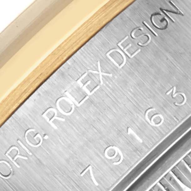 The image shows a close-up of the side engraving on the bezel, highlighting the "ORIG. ROLEX DESIGN" and serial number on the Rolex Datejust 79163 Women's Steel and Gold (two tone) White Dial 79163 Women's Steel and Gold (two tone) White Dial.