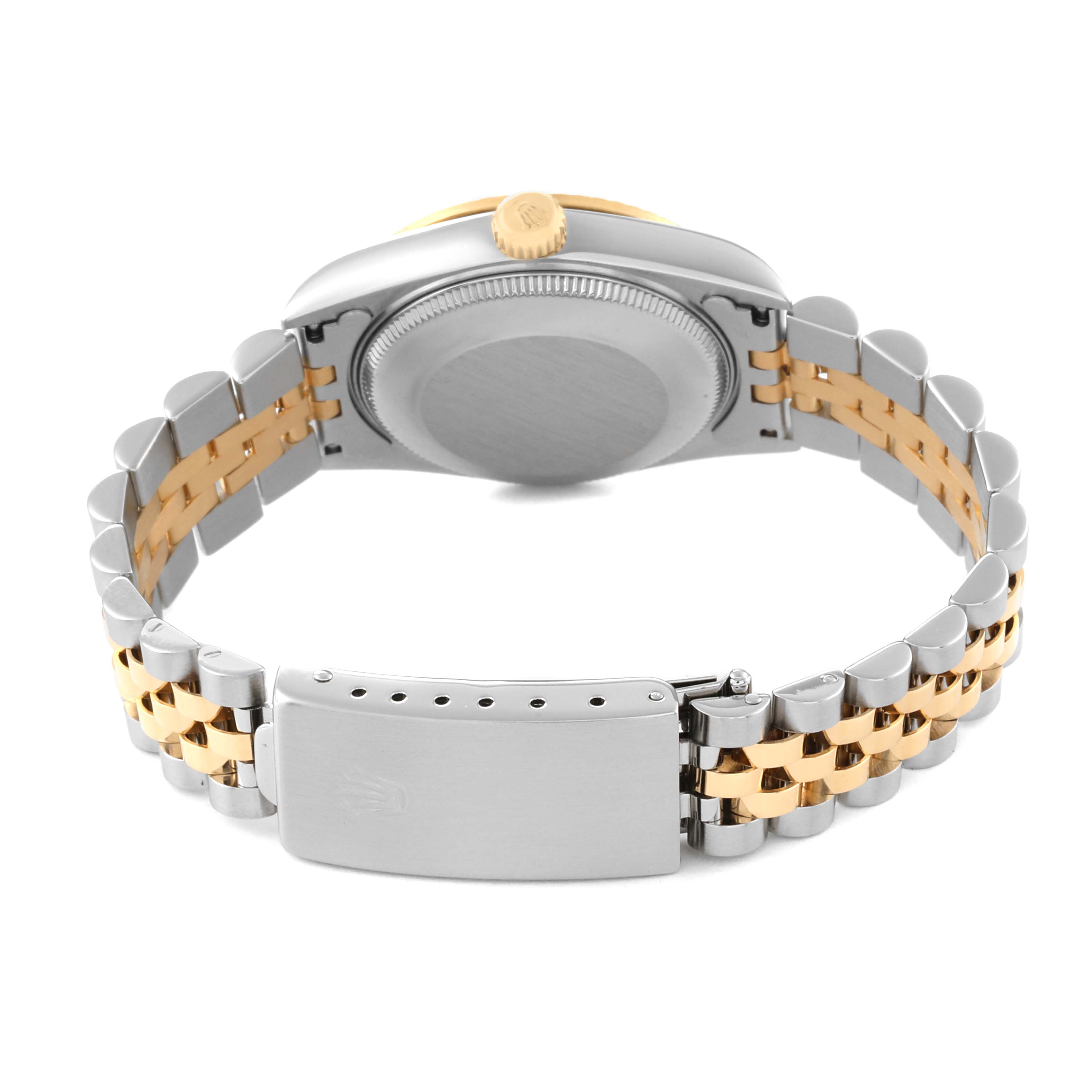 The image shows the back view of a Mid-Size Rolex watch, highlighting its case back, crown, and two-tone metal bracelet.