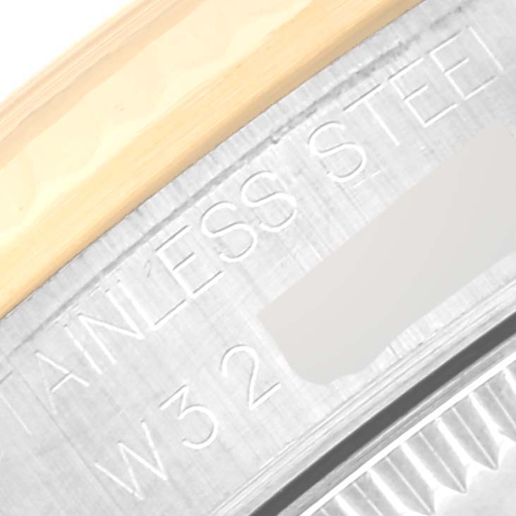 The image shows a close-up of the stainless steel and gold components on the back casing of a Mid-Size Rolex watch.