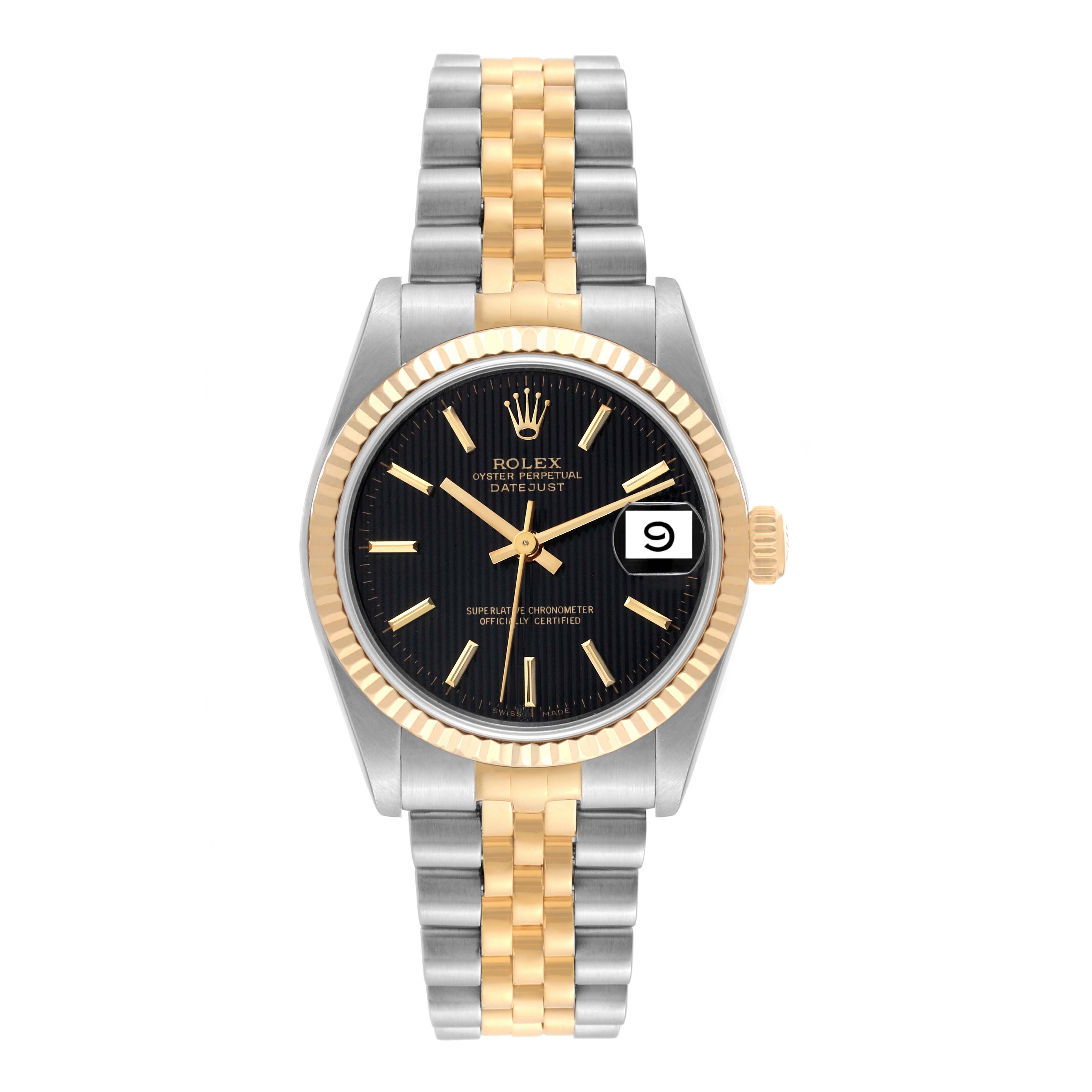 The image shows a front view of a Rolex Datejust Mid-Size watch with a black dial, gold fluted bezel, and two-tone bracelet.