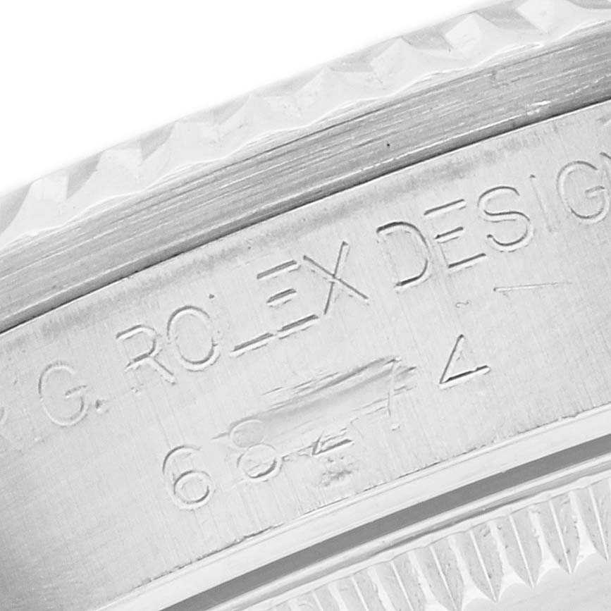 The image shows an angled close-up of the engraved side of a Rolex Mid-Size 68274 Women's Stainless Steel Mother of Pearl Dial 68274 Women's Stainless Steel Mother of Pearl Dial watch case.