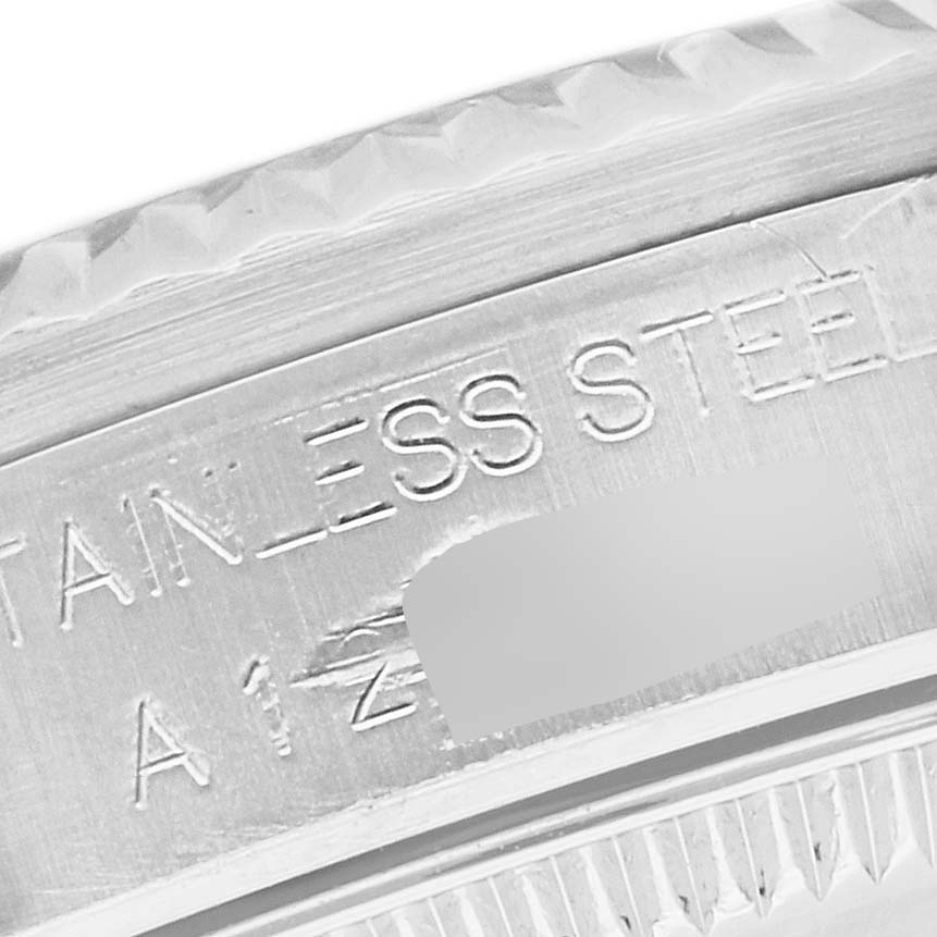 A close-up angle showing the engraving detail of the stainless steel bezel of a Rolex Mid-Size 68274 Women's Stainless Steel Mother of Pearl Dial 68274 Women's Stainless Steel Mother of Pearl Dial model watch.