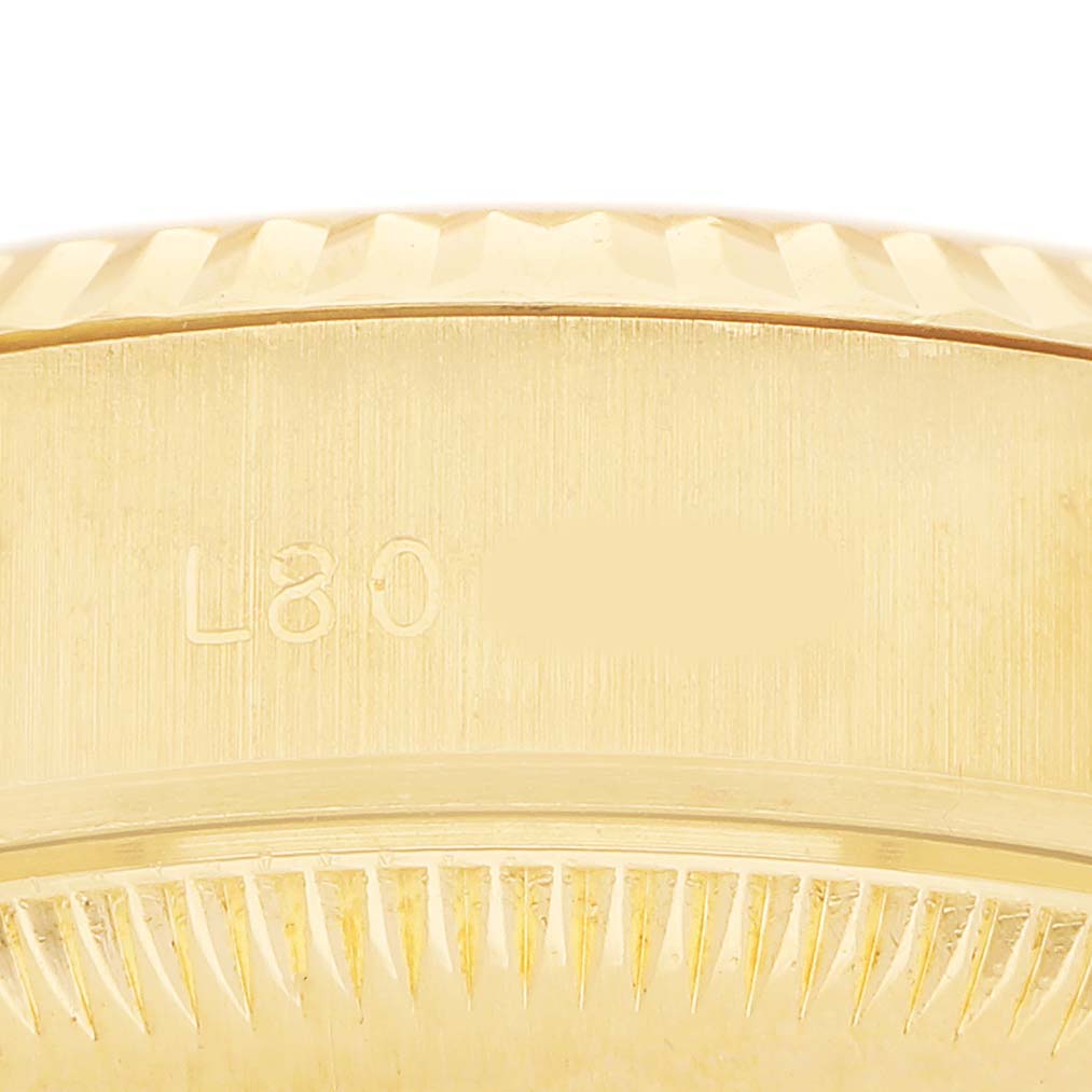 The image shows a close-up of the side of the Rolex President 69178 Women's Yellow Gold White Dial watch case with serial numbers engraved.