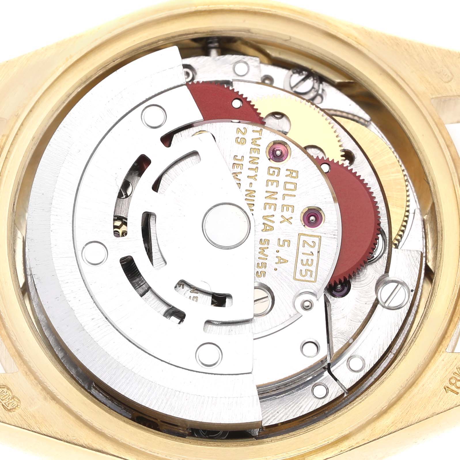 The image shows the movement of a Rolex President 69178 Women's Yellow Gold White Dial watch, focusing on its intricate mechanical parts from a top angle.