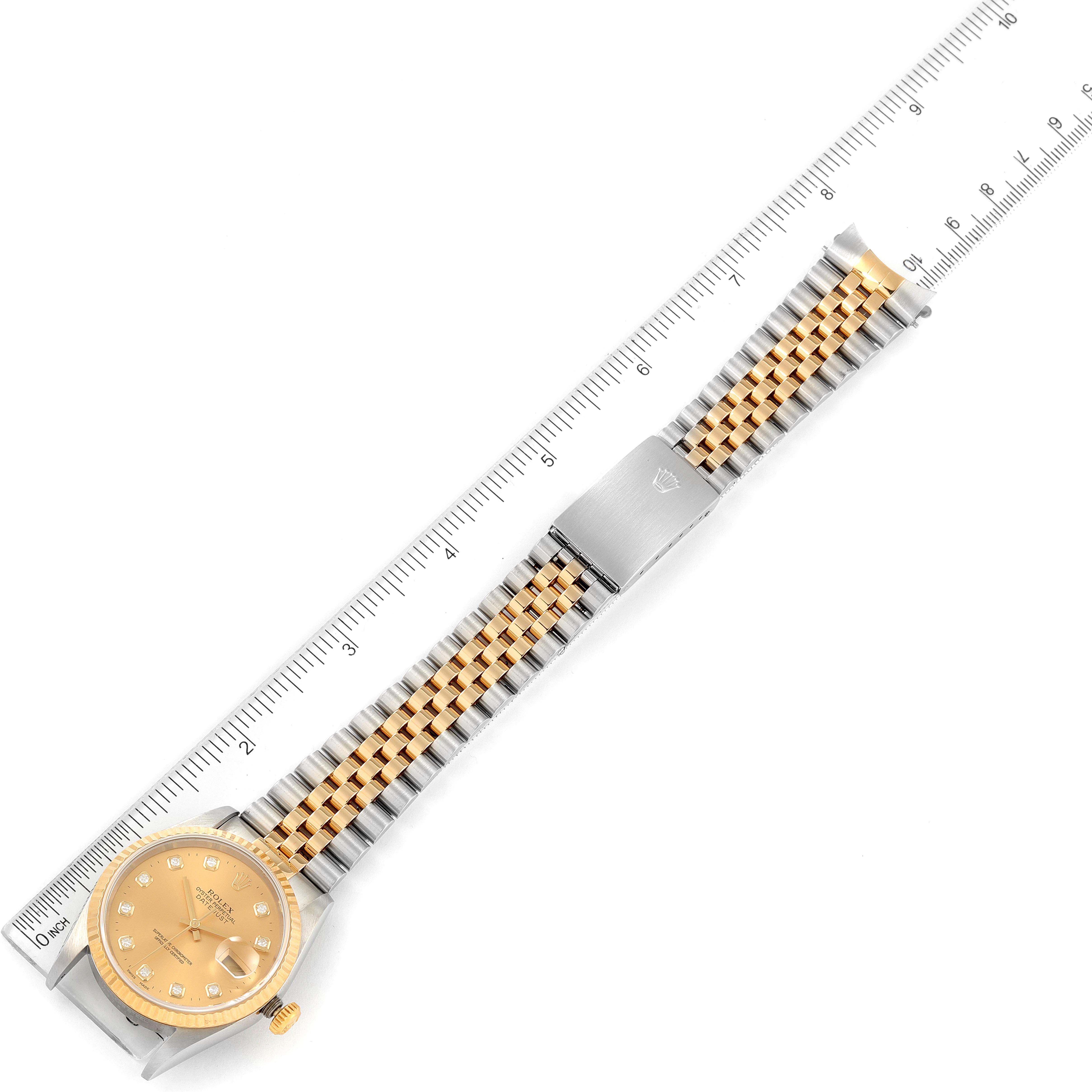 The image shows a Rolex Datejust 16233 Men's Steel and Gold (two tone) Champagne Dial 16233 Men's Steel and Gold (two tone) Champagne Dial watch from a top-down view, with the watch strap and a linear measuring ruler.