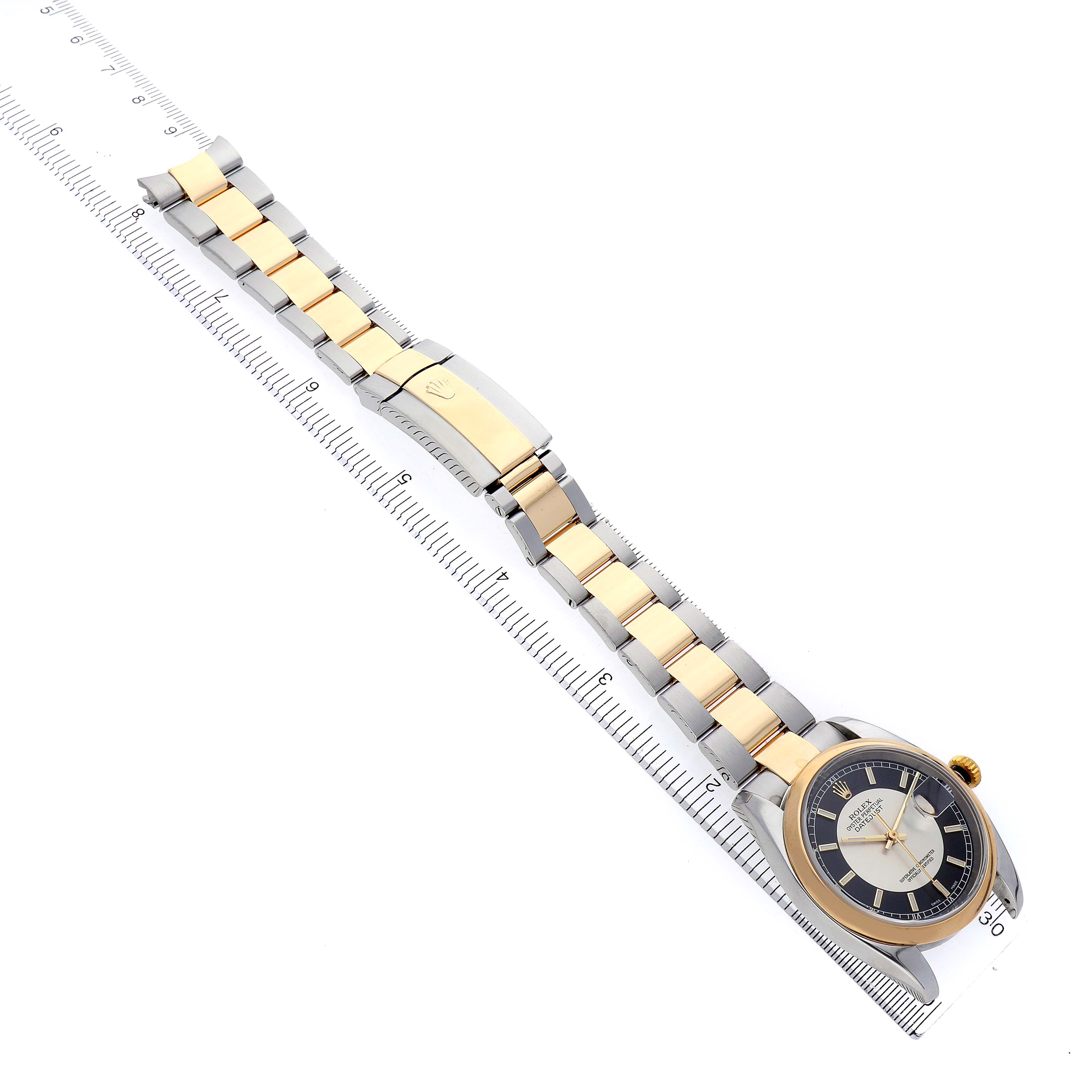 The Rolex Datejust 116203 Men's Steel and Gold (two tone) Silver Dial 116203 Men's Steel and Gold (two tone) Silver Dial watch is shown at an angled top view, highlighting the dial, bezel, and metal bracelet with gold center links.