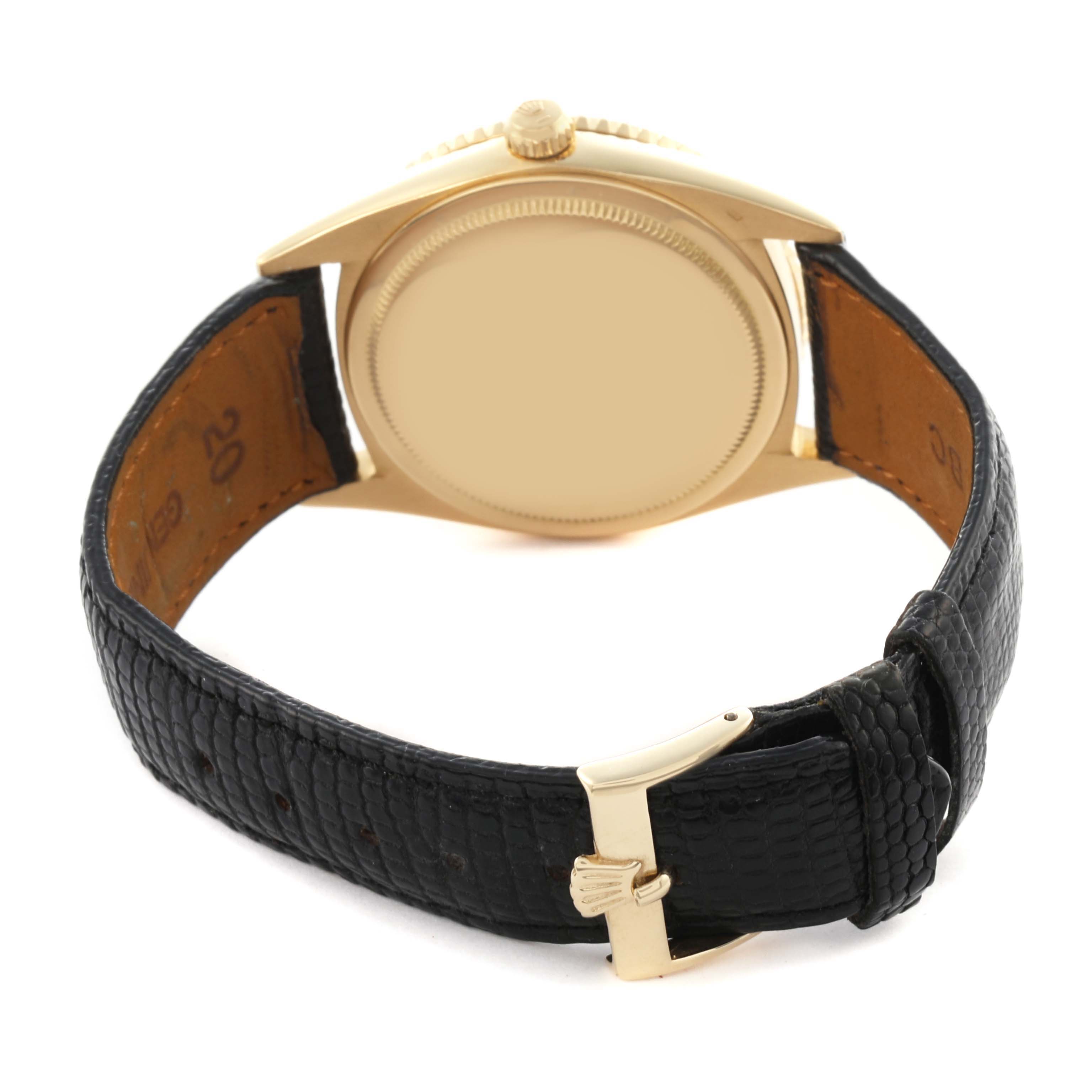 The image shows the back case and strap of a Rolex Turn-o-Graph watch from a rear angle, highlighting the buckle and leather strap texture.