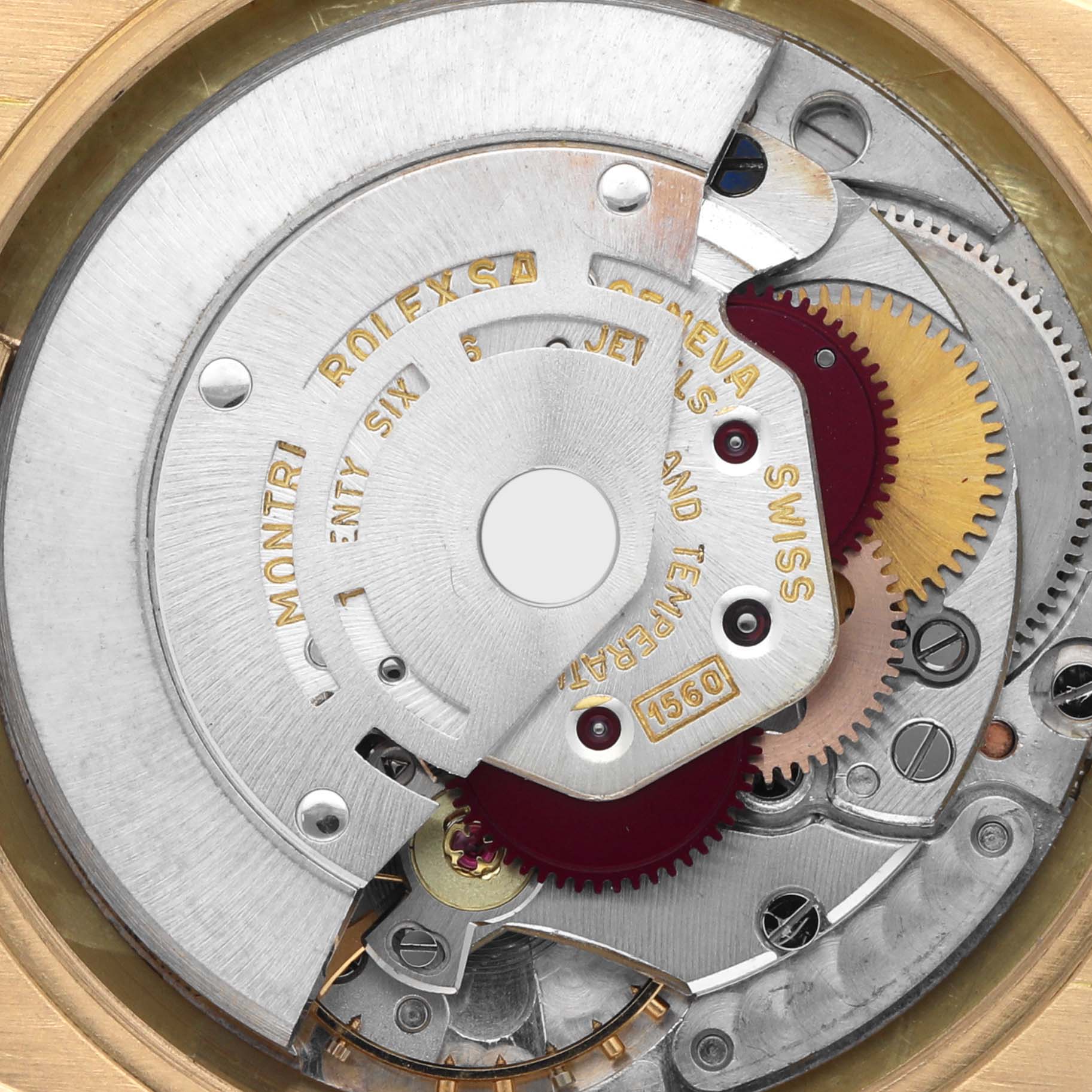The image shows the internal movement mechanism of a Rolex Turn-o-Graph watch, highlighting gears and engraved details.