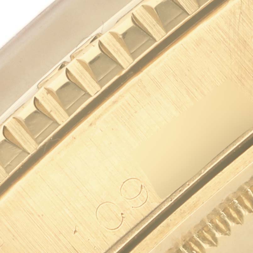 The image shows a close-up of the bezel and edge of a Rolex Turn-o-Graph watch, highlighting its fluted design.