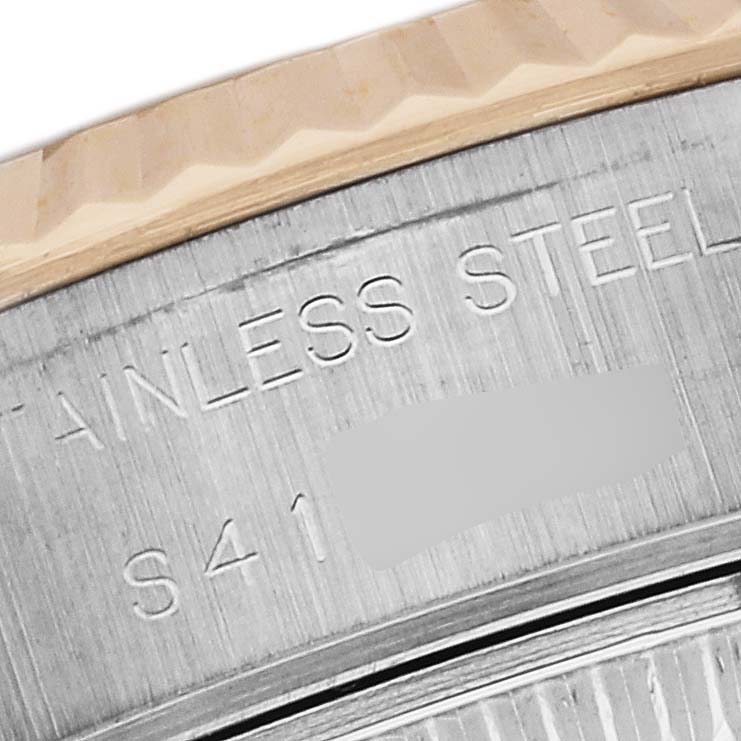 Close-up view of a Rolex Datejust 69173 Women's Steel and Gold (two tone) White Dial 69173 Women's Steel and Gold (two tone) White Dial watch bezel and part of the engraved text on the stainless steel case.