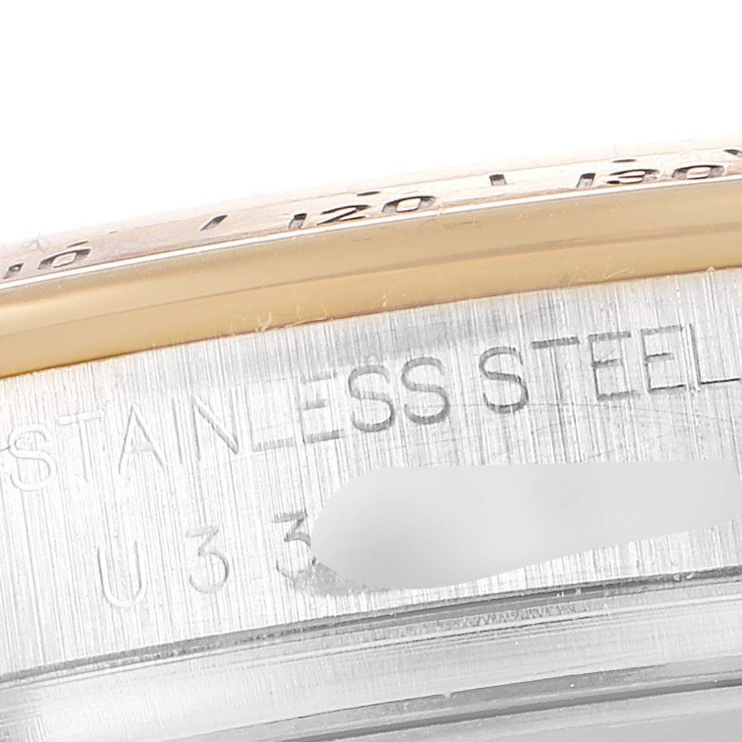 This image shows a close-up of the side engraving on a Rolex Daytona 16523 Men
s Steel and Gold (two tone) White Dial 16523 Men
s Steel and Gold (two tone) White Dial watch, highlighting the "STAINLESS STEEL" text.