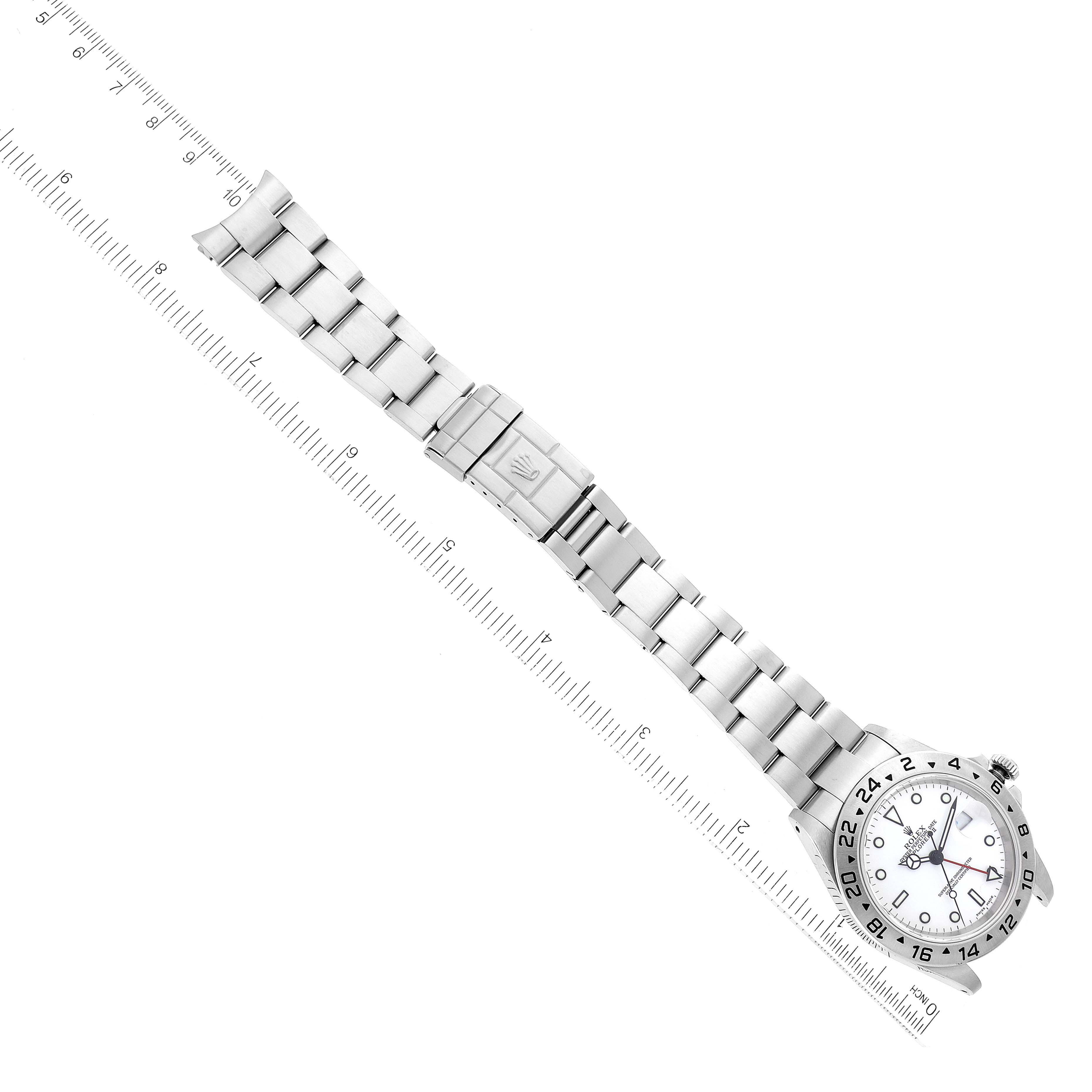 This image shows a Rolex Explorer 16570 Men's Stainless Steel White Dial 16570 Men's Stainless Steel White Dial watch laid flat, displaying the face, case, and entire bracelet, with a ruler for scale.