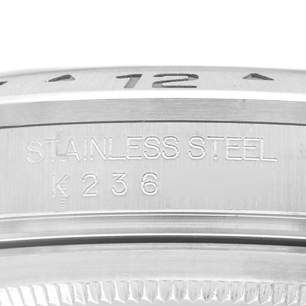 The image shows a close-up of the bezel and case side with engravings on a Rolex Explorer 16570 Men's Stainless Steel White Dial 16570 Men's Stainless Steel White Dial model watch.