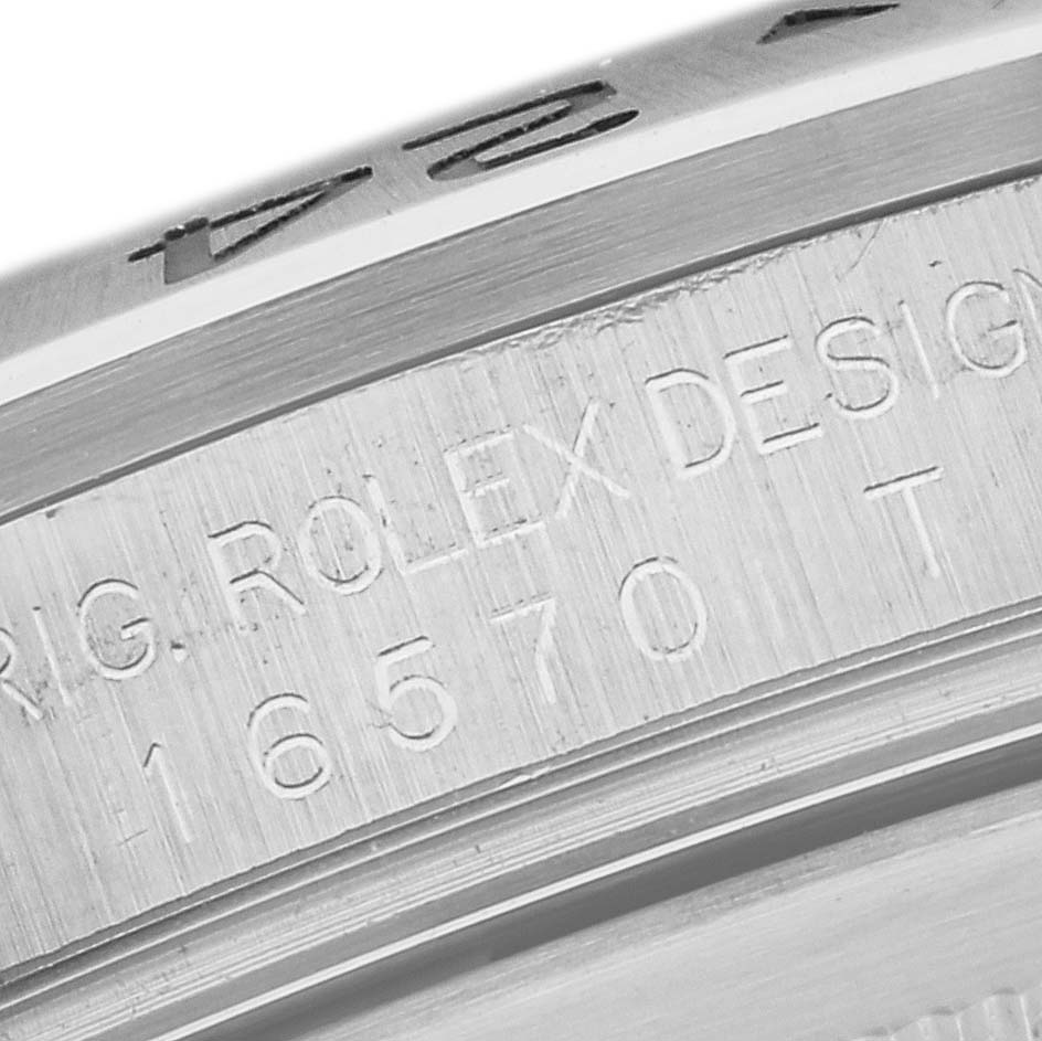 This close-up shows the engraved bezel and case side of the Rolex Explorer 16570T Men's Stainless Steel White Dial 16570T Men's Stainless Steel White Dial model.