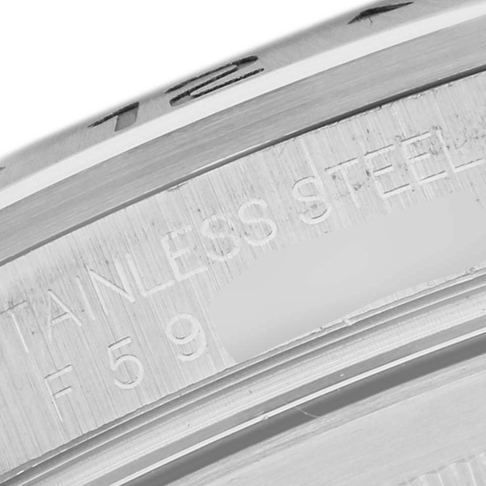 The image shows a close-up angle of the engraved text on the bezel of a Rolex Explorer 16570T Men's Stainless Steel White Dial 16570T Men's Stainless Steel White Dial watch.