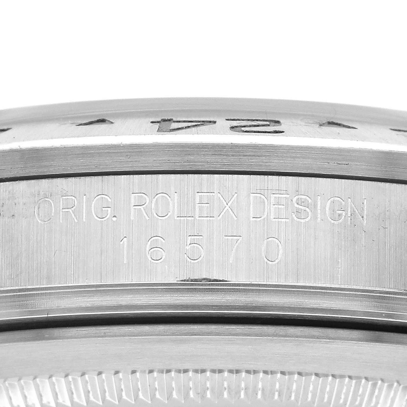 The image shows a close-up of the edge of a Rolex Explorer 16570 Men's Stainless Steel White Dial 16570 Men's Stainless Steel White Dial watch, featuring the engraved model number 16570.