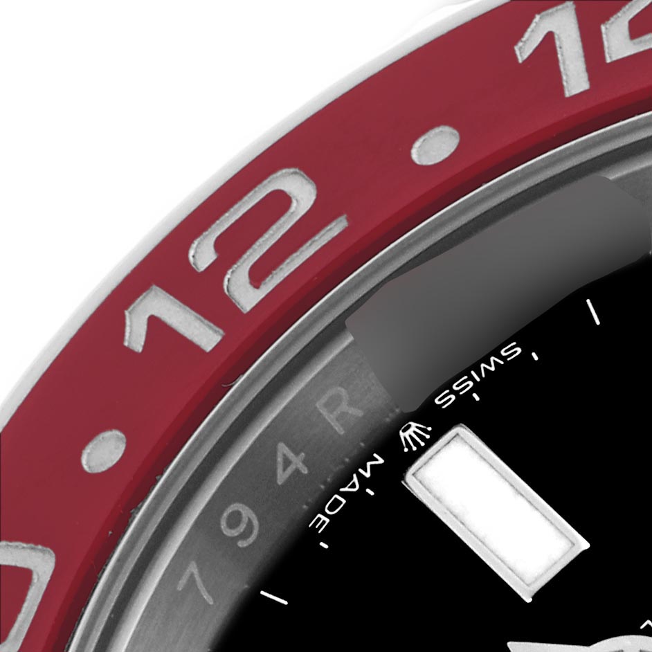 The image shows a close-up of the bezel and partial dial of the Rolex GMT-Master 126710BLRO Men's Stainless Steel Black Dial 126710BLRO Men's Stainless Steel Black Dial, highlighting the "12" mark and part of the face.