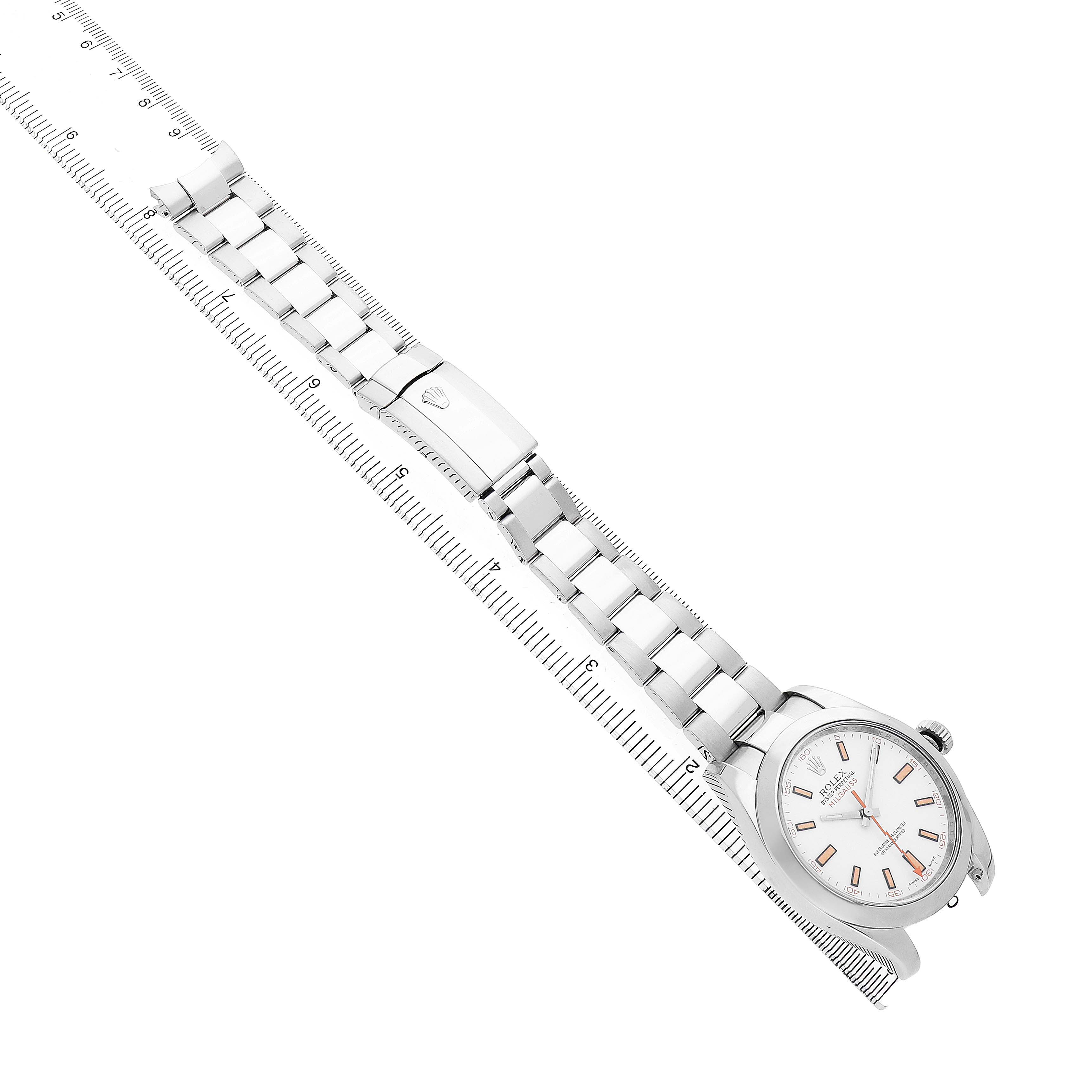 The image shows the Rolex Milgauss 116400 Men's Stainless Steel White Dial watch at an angled top view, detailing the bracelet and clasp alongside a ruler.