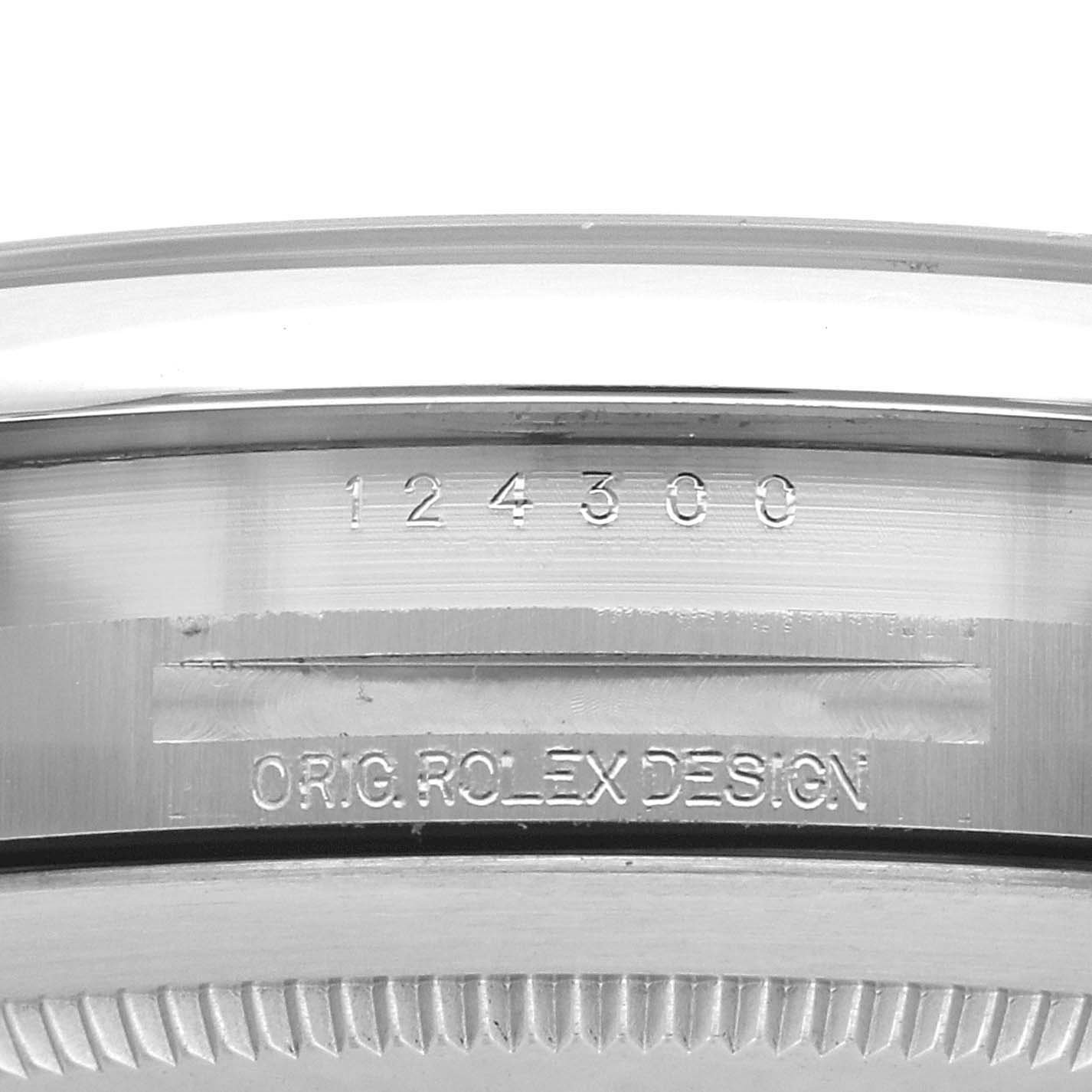 The image shows a side angle of the Rolex Oyster Perpetual 124300 Men's Stainless Steel Green Dial 124300 Men's Stainless Steel Green Dial, focusing on the engraved bezel and casing.