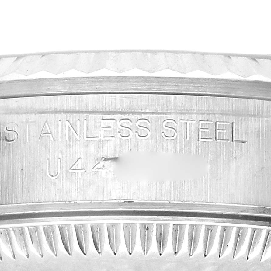 The image shows a close-up of the case edge with "STAINLESS STEEL" engraving on the Rolex Oyster Perpetual 67194 Women's Stainless Steel Blue Dial 67194 Women's Stainless Steel Blue Dial watch.