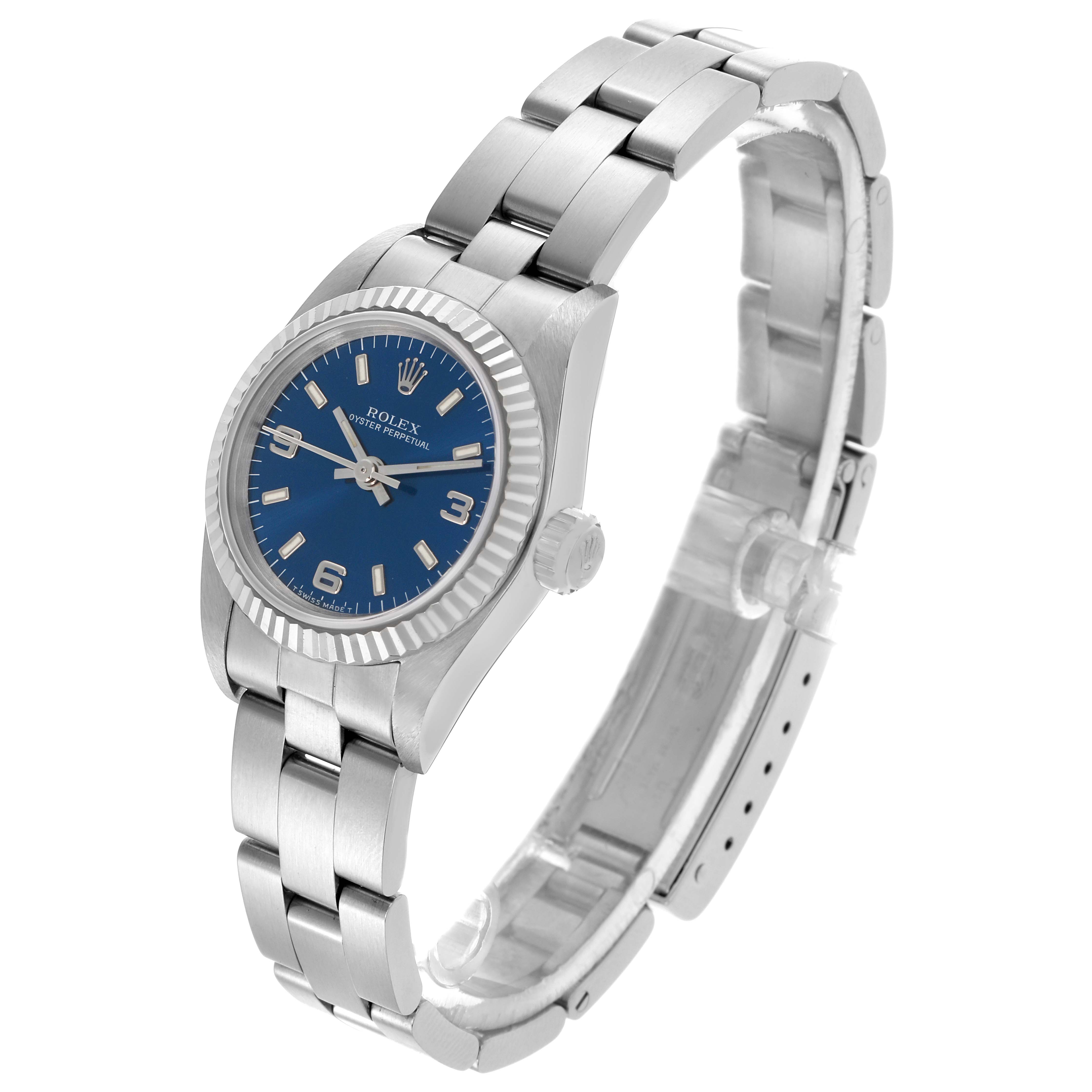 The Rolex Oyster Perpetual 67194 Women's Stainless Steel Blue Dial 67194 Women's Stainless Steel Blue Dial watch is shown at a three-quarter angle, highlighting the blue dial, fluted bezel, and bracelet.