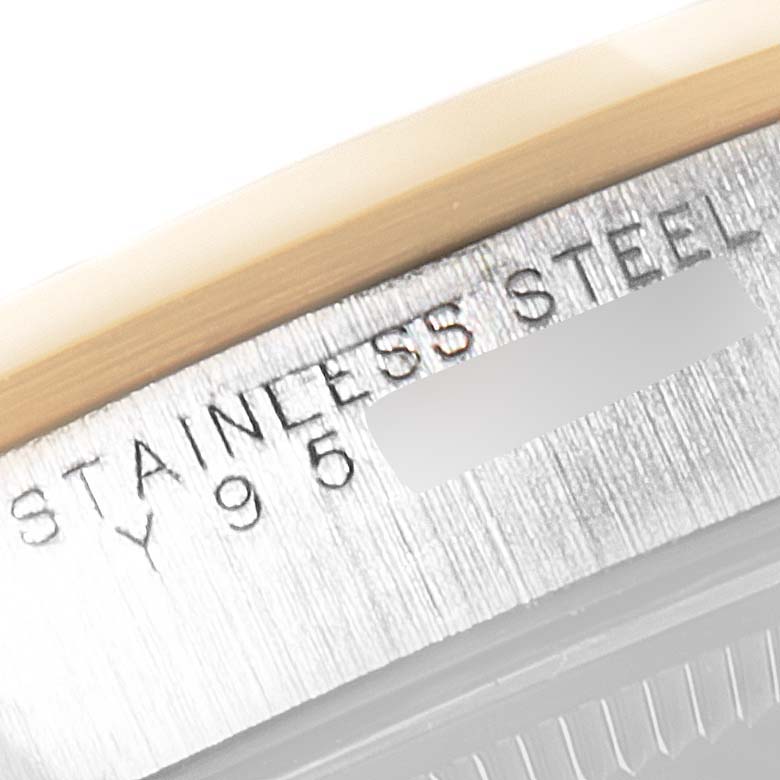 This image shows a close-up of the side casing of a stainless steel Rolex Oyster Perpetual 14203M Men's Steel and Gold (two tone) Grey Dial 14203M Men's Steel and Gold (two tone) Grey Dial watch, displaying part of the engraved serial number.