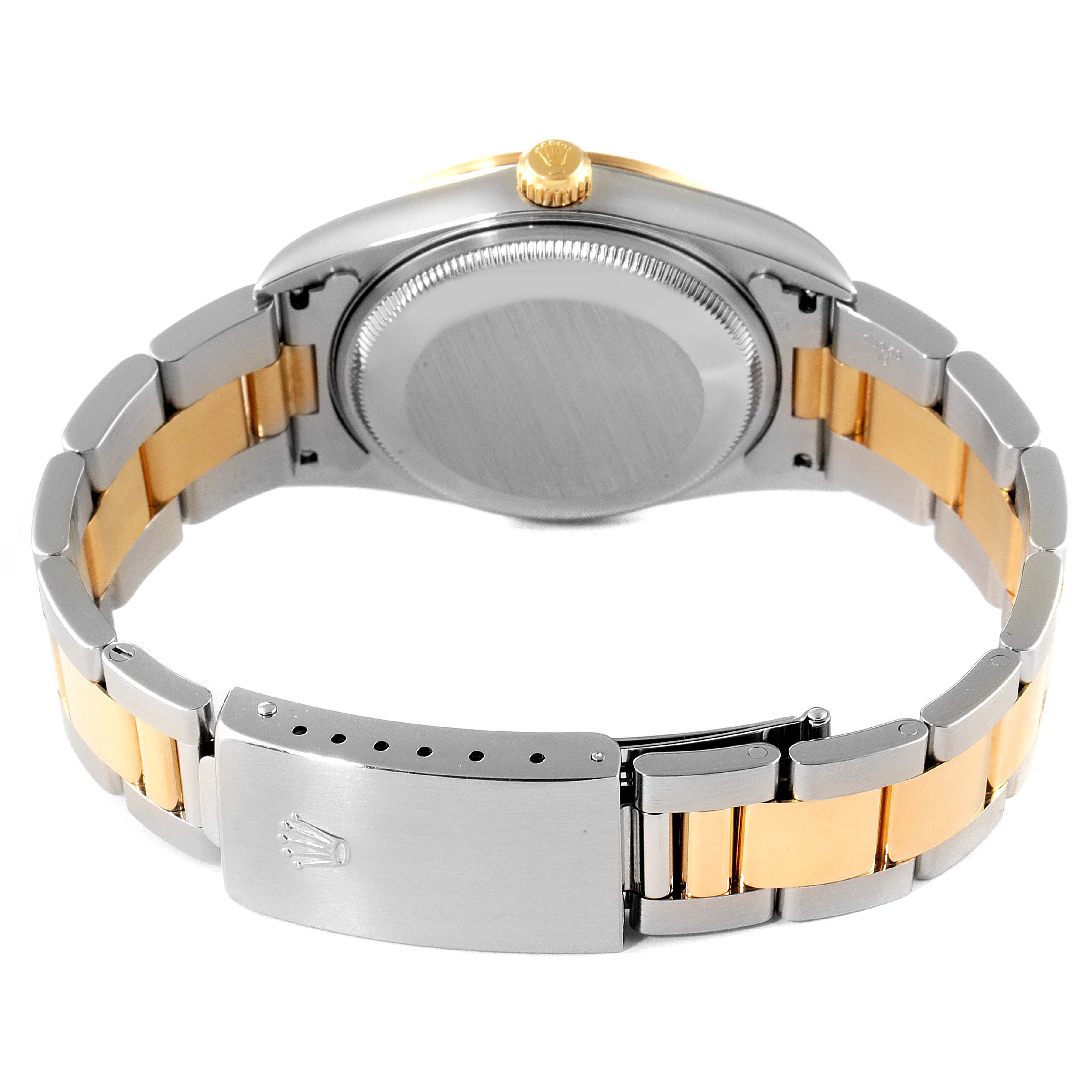 The image shows the back and clasp of a Rolex Oyster Perpetual 14203M Men's Steel and Gold (two tone) Grey Dial 14203M Men's Steel and Gold (two tone) Grey Dial watch, highlighting the two-tone bracelet and crown.