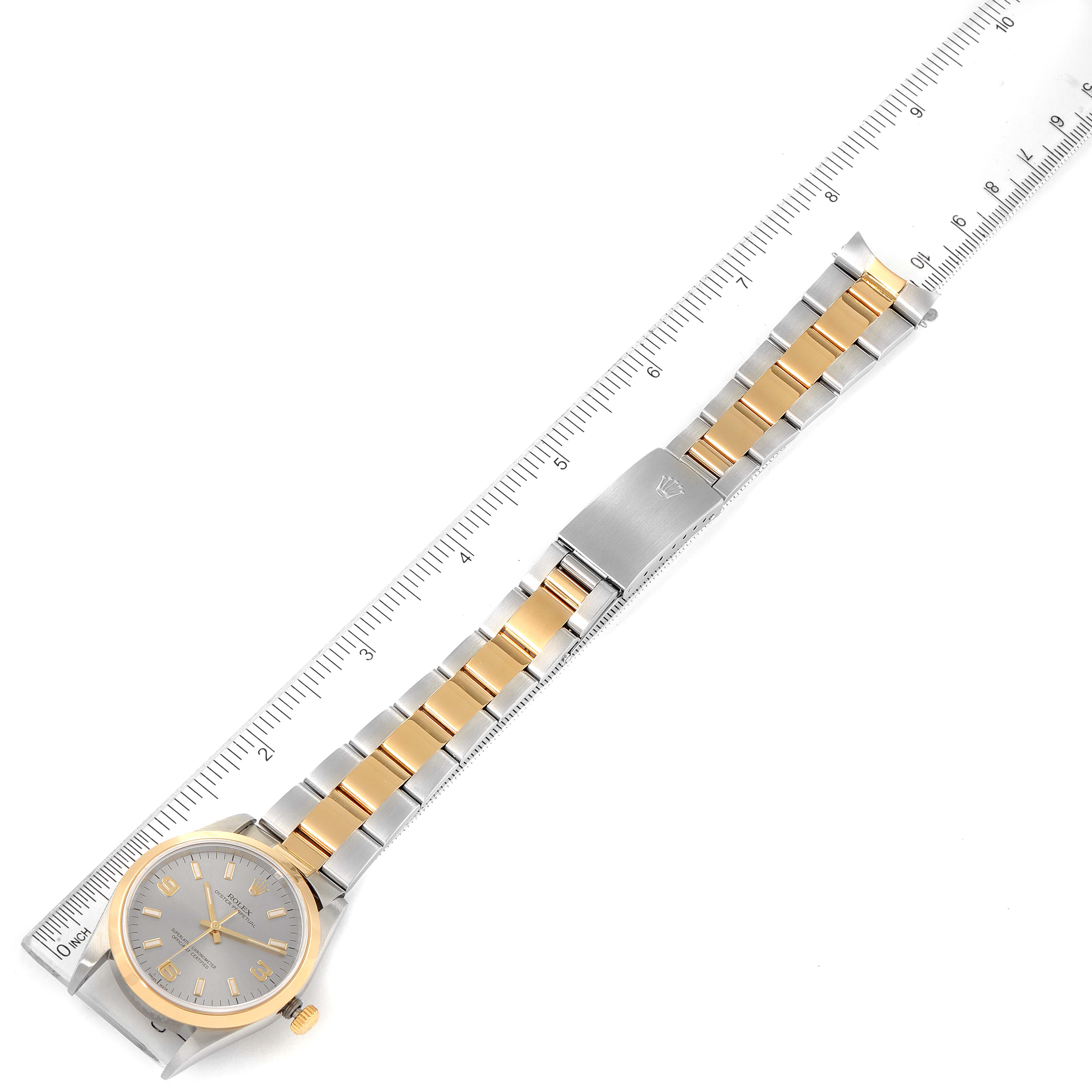 The image shows a top view of a Rolex Oyster Perpetual 14203M Men's Steel and Gold (two tone) Grey Dial 14203M Men's Steel and Gold (two tone) Grey Dial watch with its ruler-measured two-tone bracelet, clasp, and face.