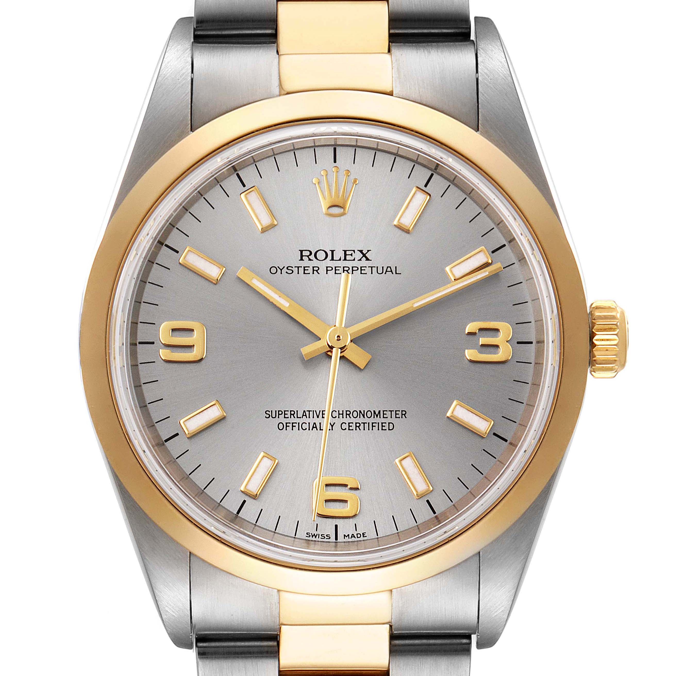 The image shows a front view of a Rolex Oyster Perpetual 14203M Men's Steel and Gold (two tone) Grey Dial 14203M Men's Steel and Gold (two tone) Grey Dial watch, highlighting its gold and silver dial and bezel.